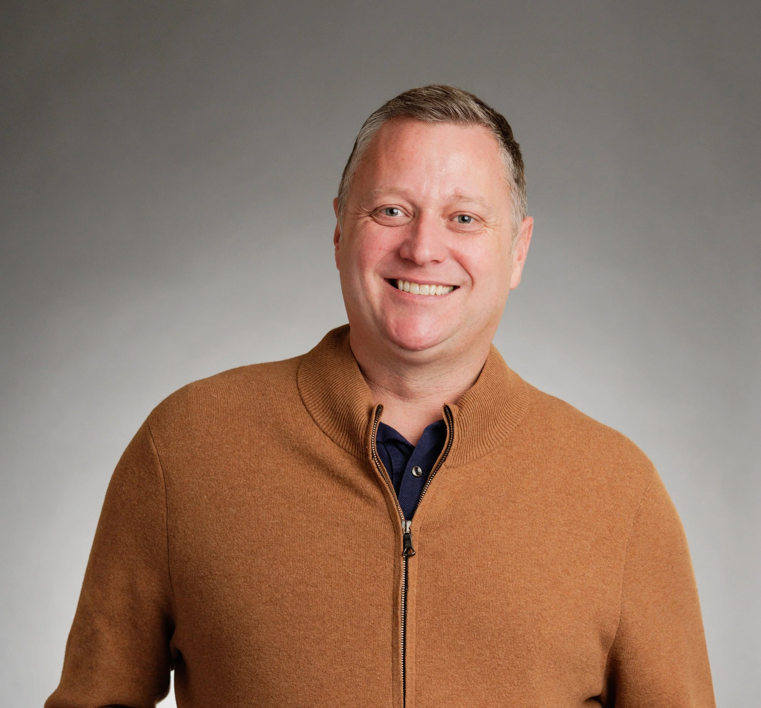 Professional headshot of Peter Munro, LCSW smiling wearing a tan sweater