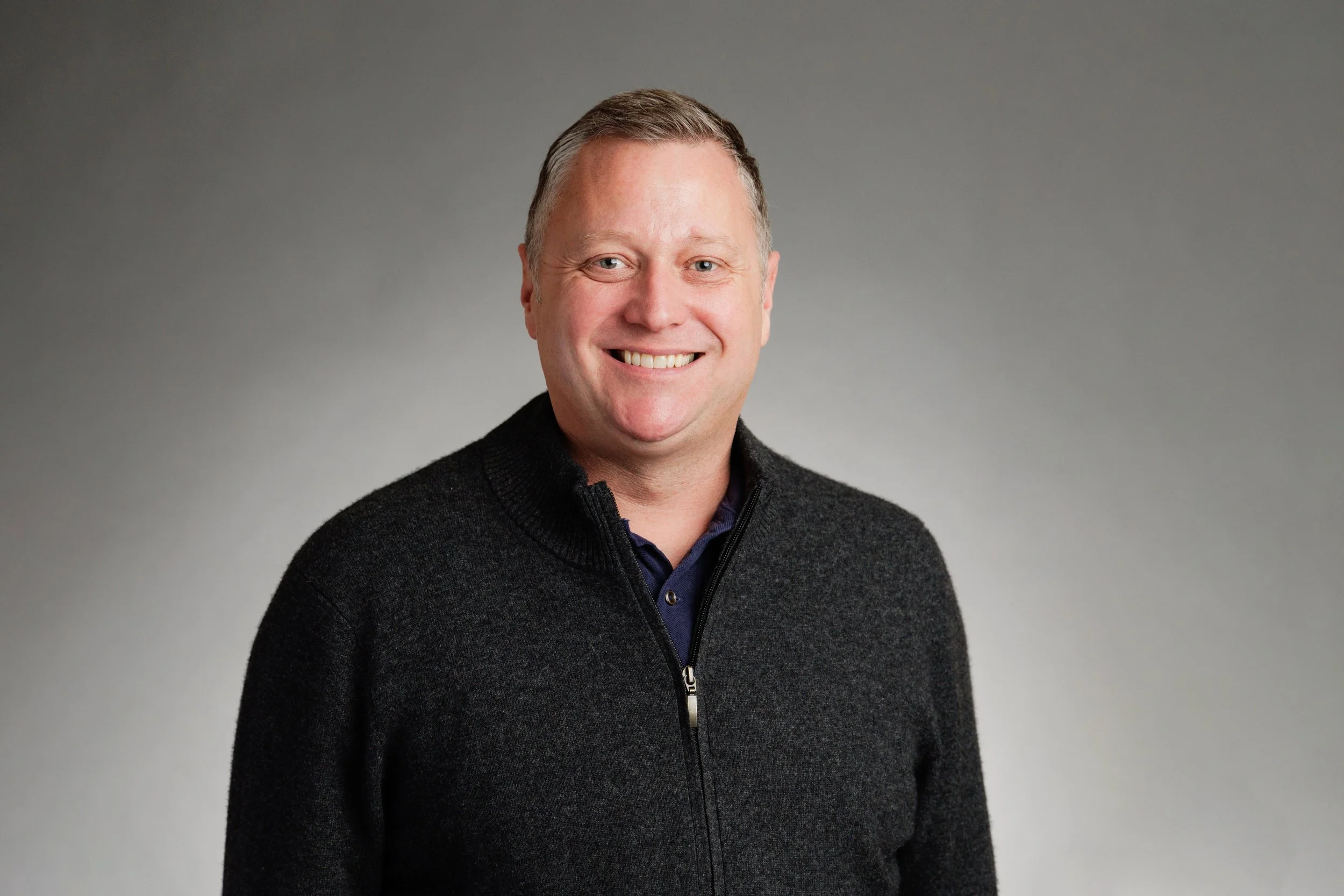 Professional headshot of Peter Munro, LCSW smiling in a dark grey sweater
