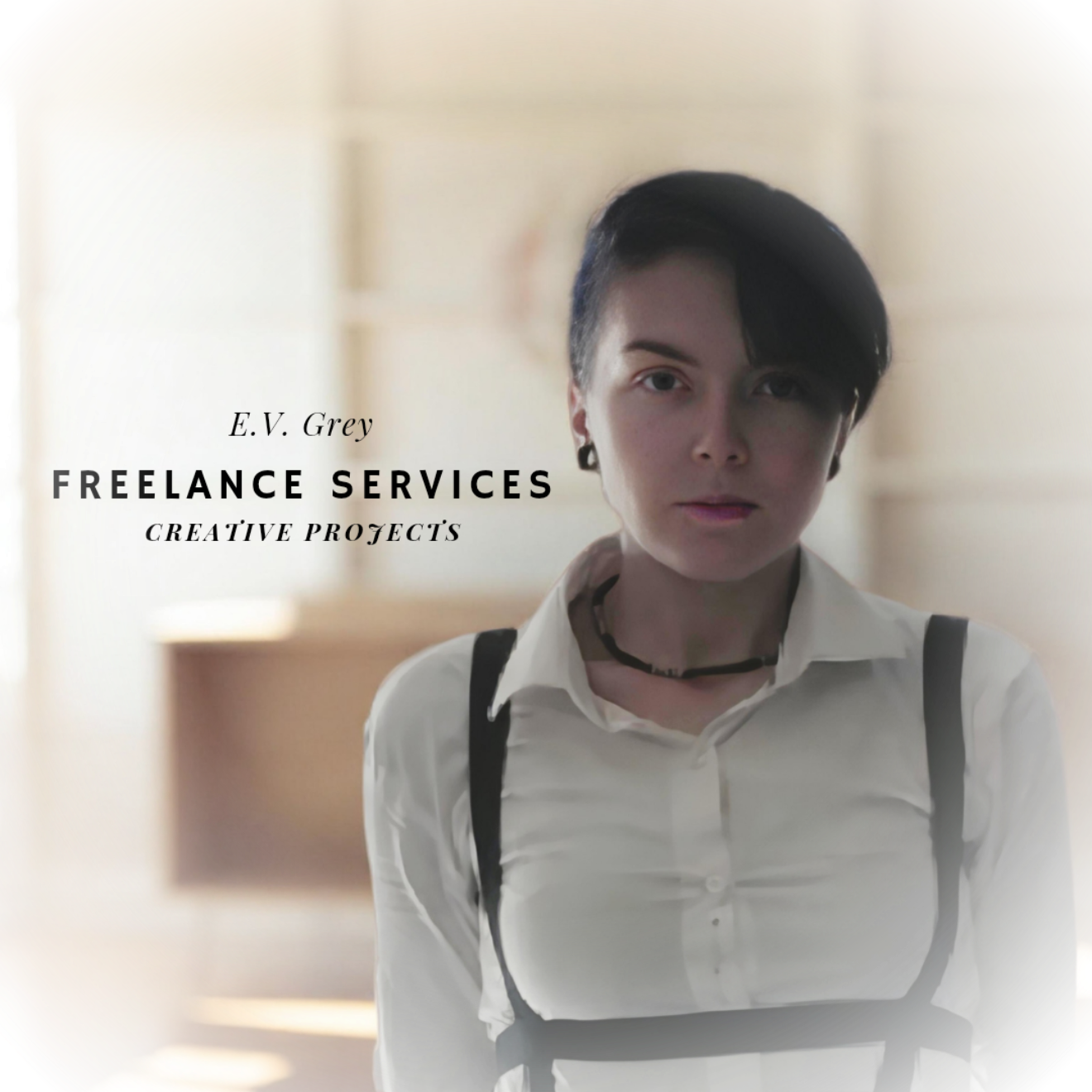 A woman with short black hair, wearing a white shirt, black suspenders, and a necklace, standing indoors with a neutral background. Text overlays read 'E.V. Grey', 'FREELANCE SERVICES', and 'CREATIVE PROJECTS'.