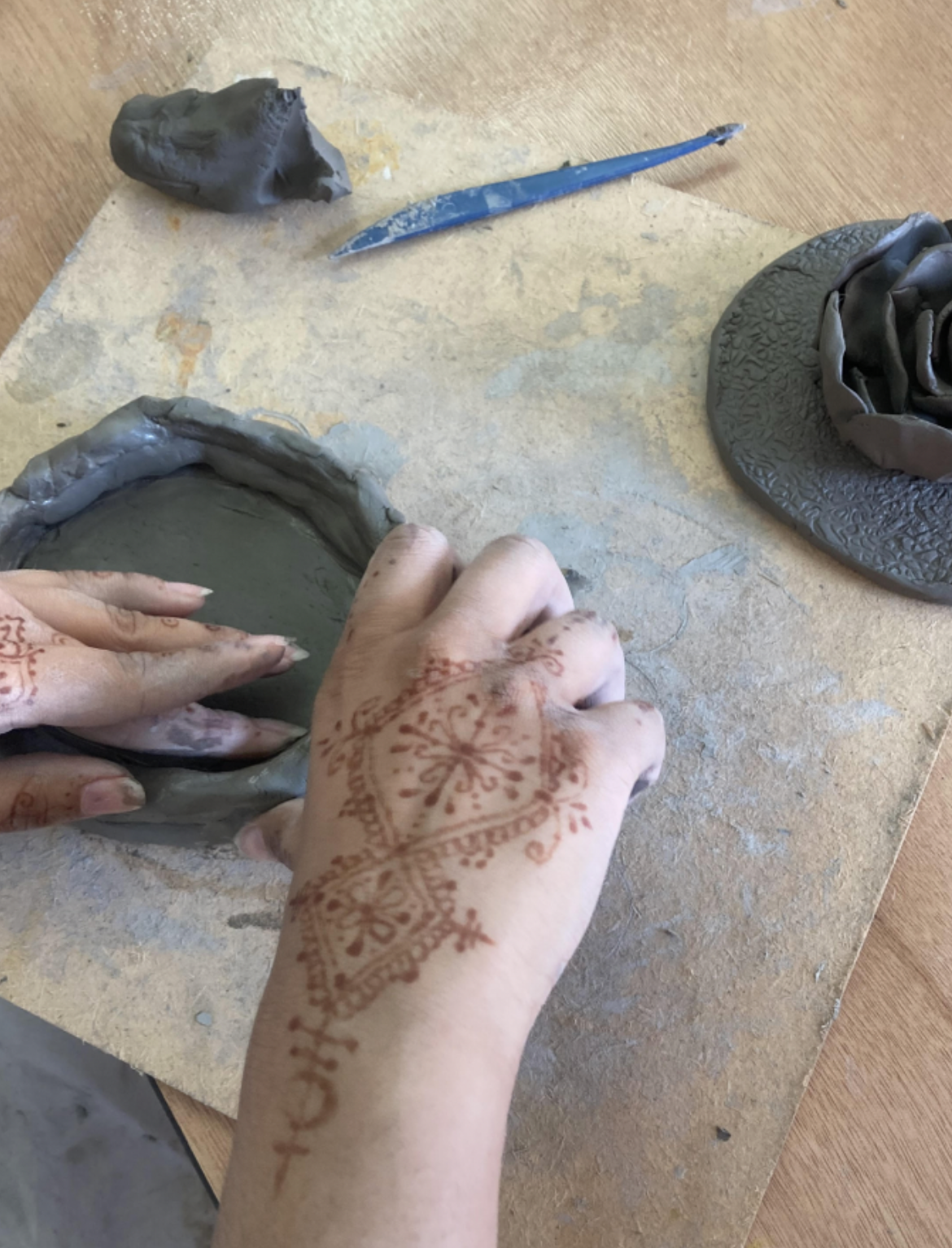 hands with clay featured in branding identity for art therapist photographer consultant