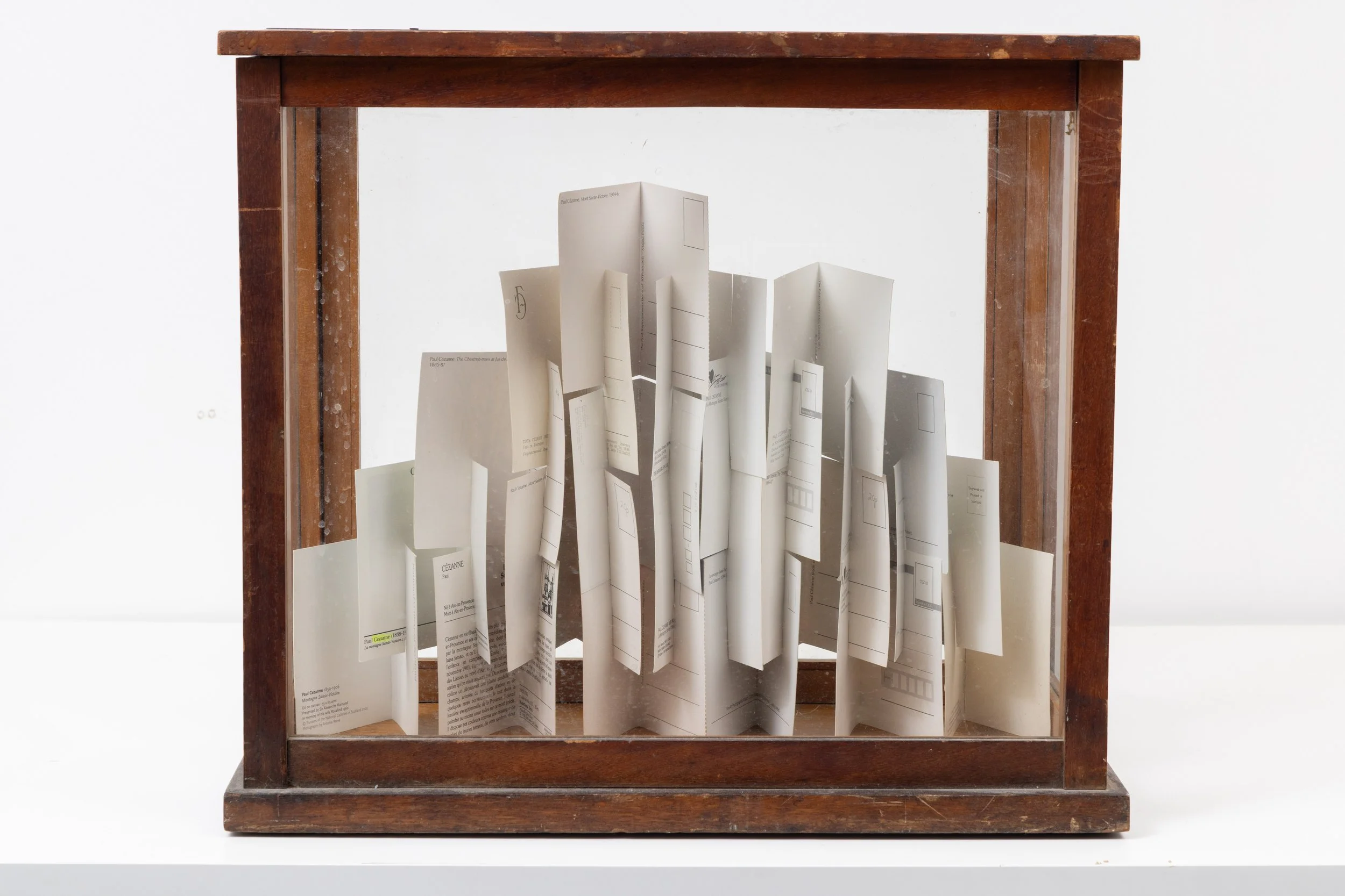 ‘Build me a mountain… (after Cézanne)’, postcards and vintage vitrine, 45 x 40 x 23 cm, 2025
