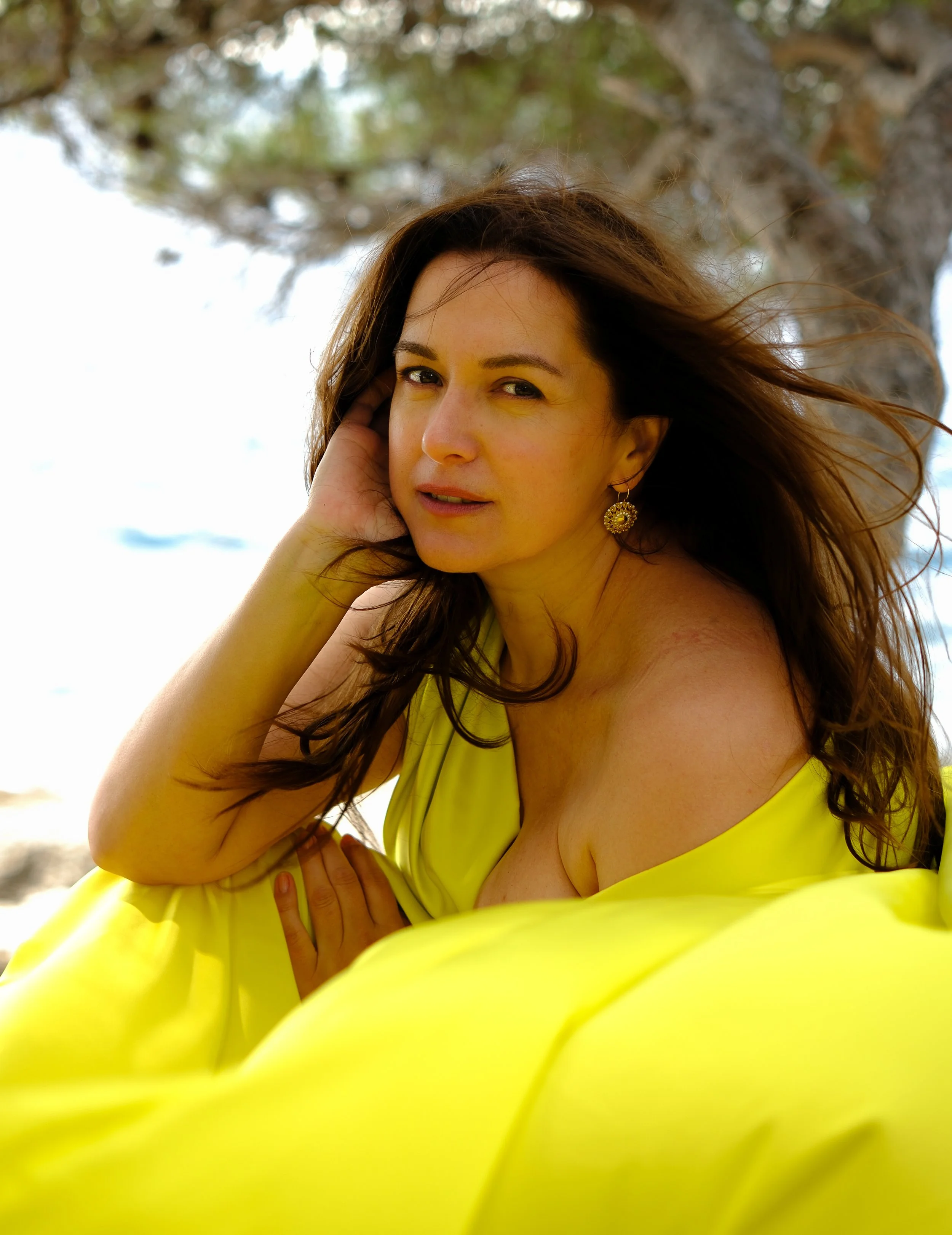 Flying dress photoshoot on the rocky coast of Croatia. Dramatic wind and sea create a cinematic and elegant atmosphere.