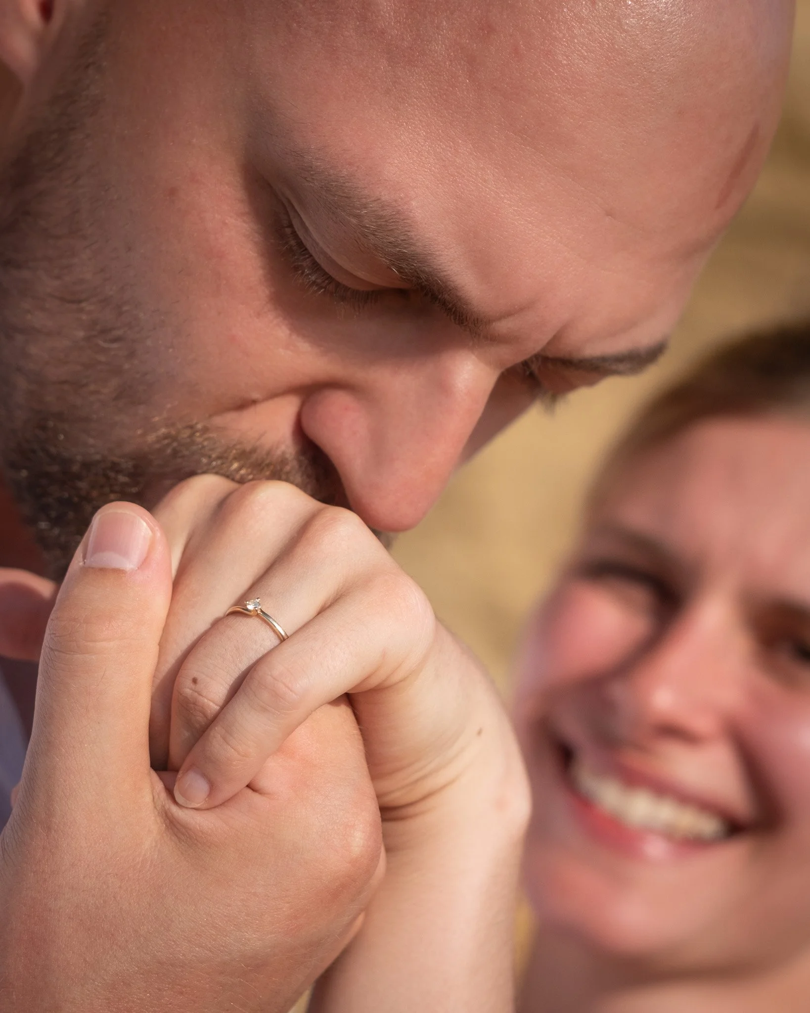 Romantic surprise proposal in Zadar, Croatia – groom-to-be kissing his fiancée's hand with an engagement ring, captured by Captured Studio.