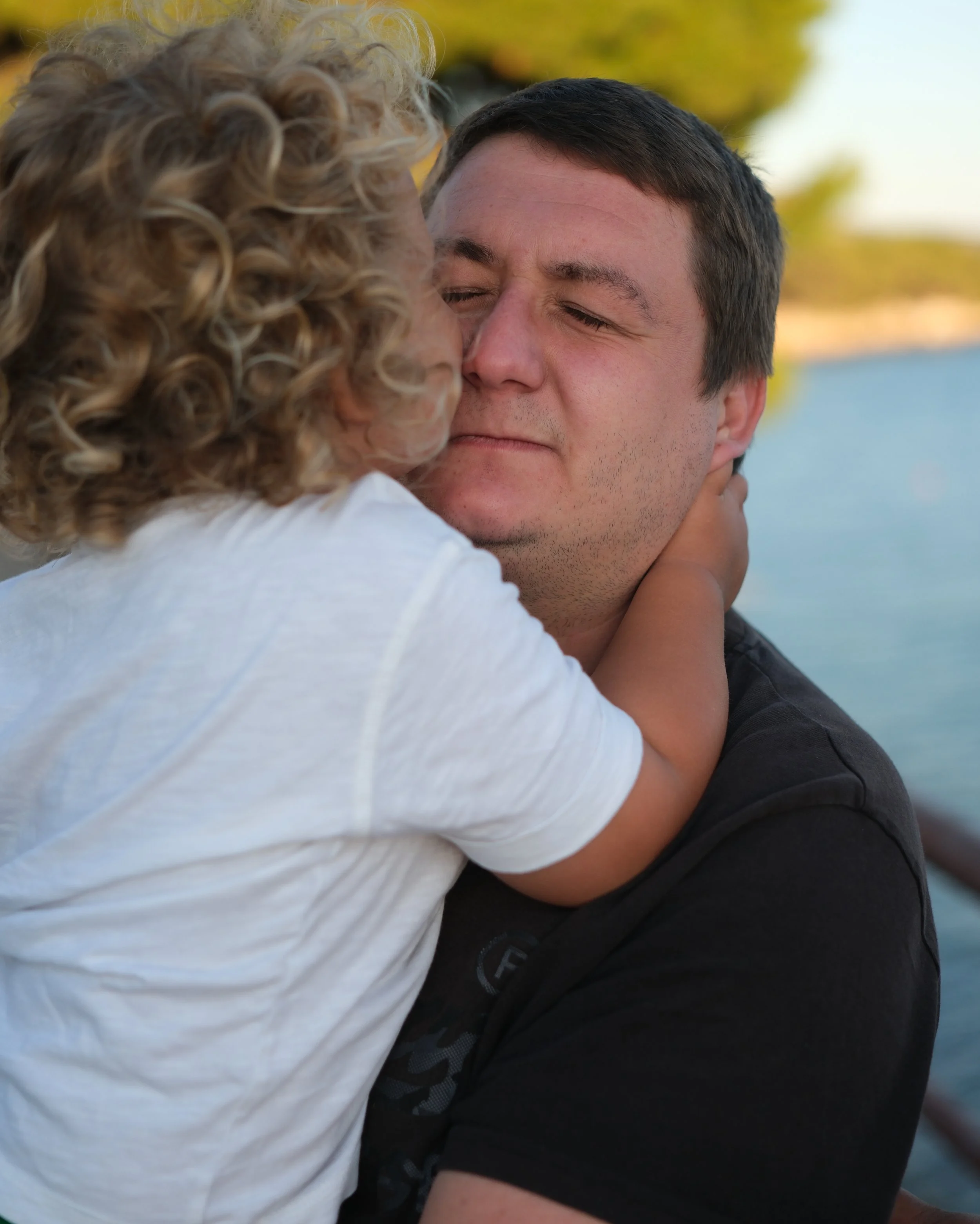 father hugging their child during a sunset family photosession Zadar