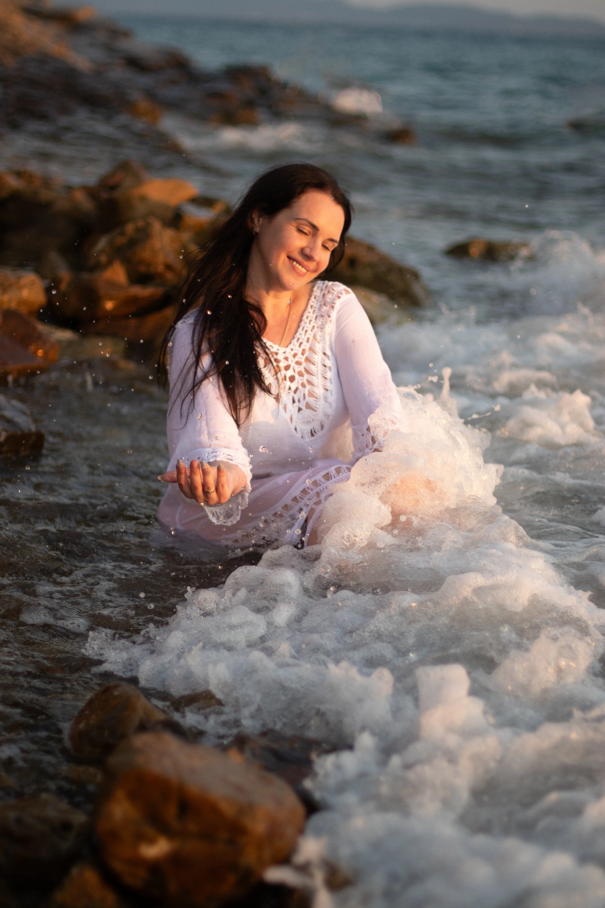 Solo travel photoshoot in Zadar, Croatia at sunset on the beach. Soft golden light, sea breeze and natural movement create a calm and emotional atmosphere, capturing freedom and feminine beauty.
