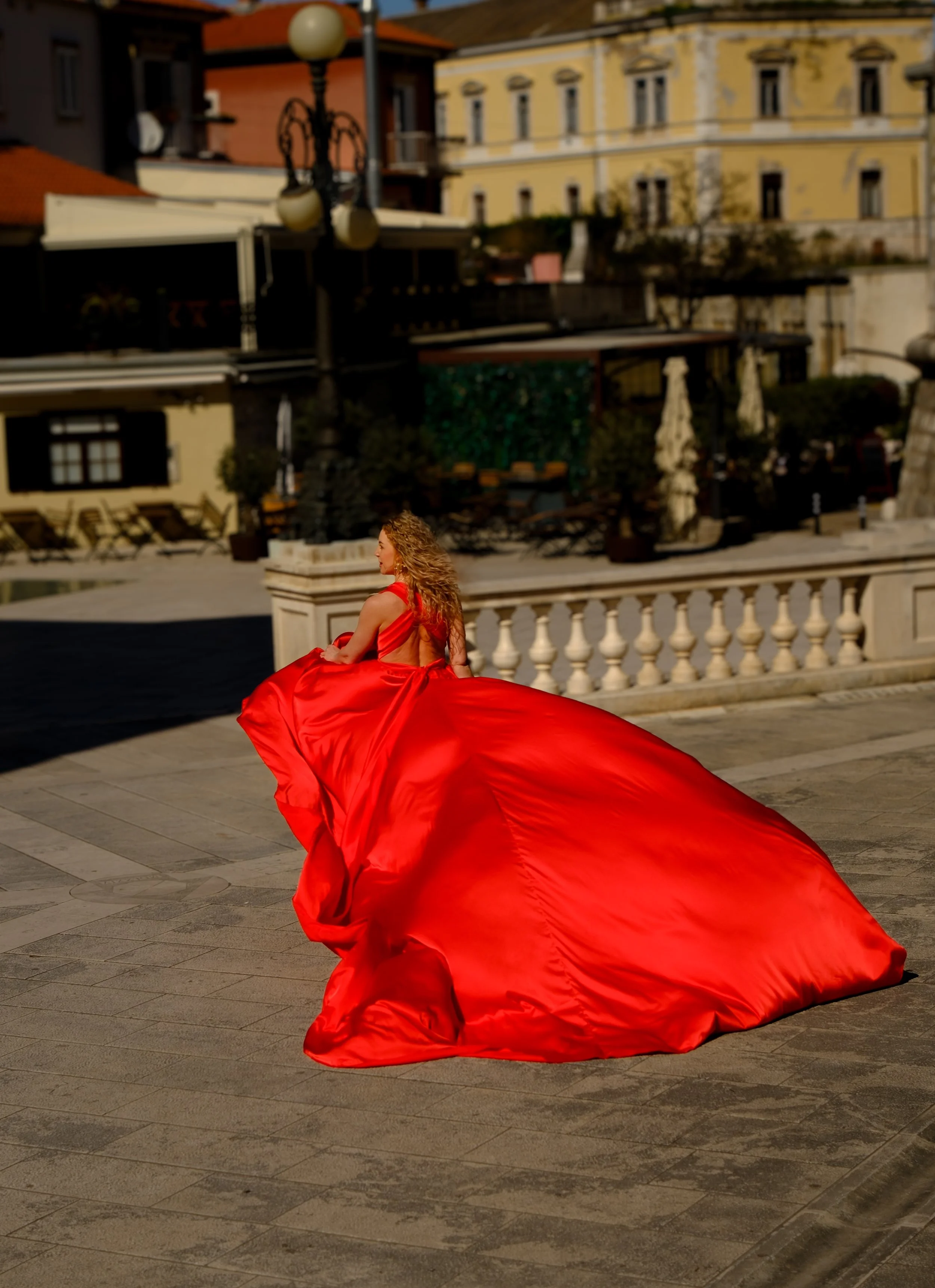 Female photoshoot in a flying dress in Zadar, Croatia. Historic streets and soft light create a stylish, cinematic and emotional visual story.
