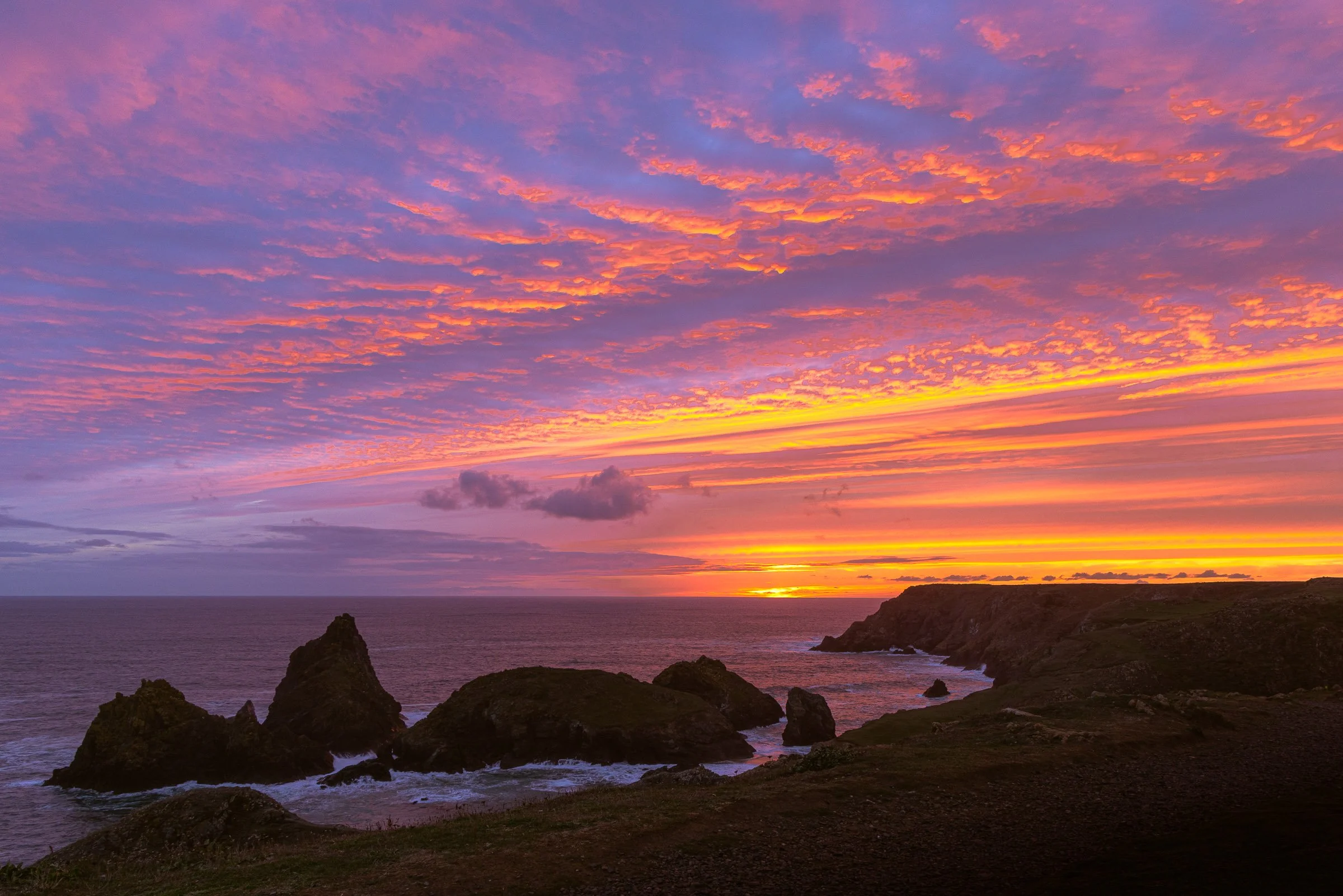 Dramatic sunset over the serpentine rock stacks at Kynance Cove Cornwall, fine art canvas by Lowena Studios