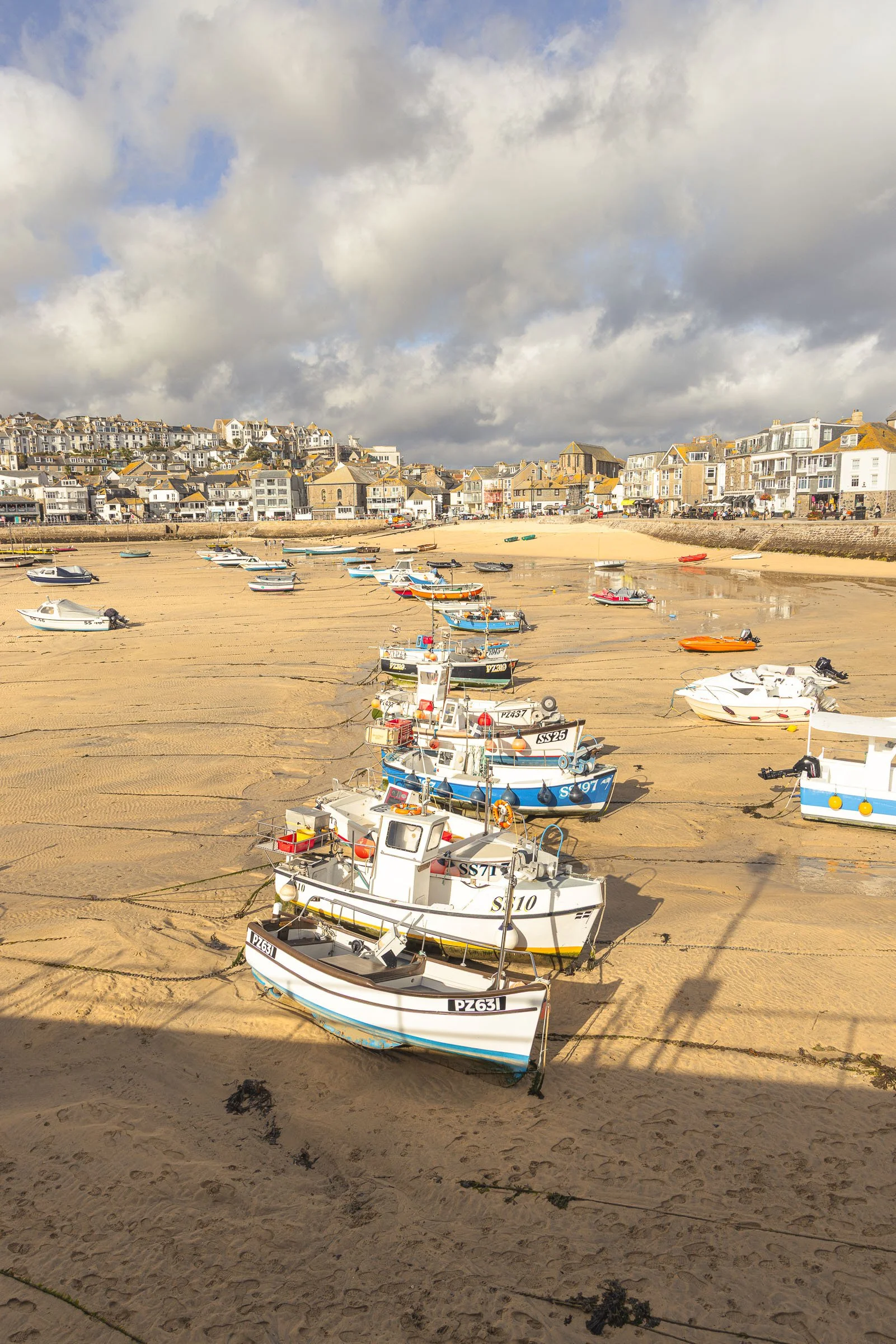 Traditional fishing boats resting on the sand at low tide in St Ives Harbour Cornwall, fine art canvas by Lowena Studios
