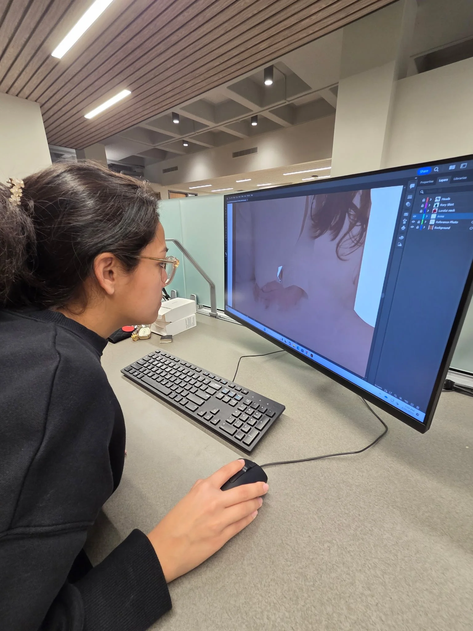 Cadence Dudley working on graphic design project.