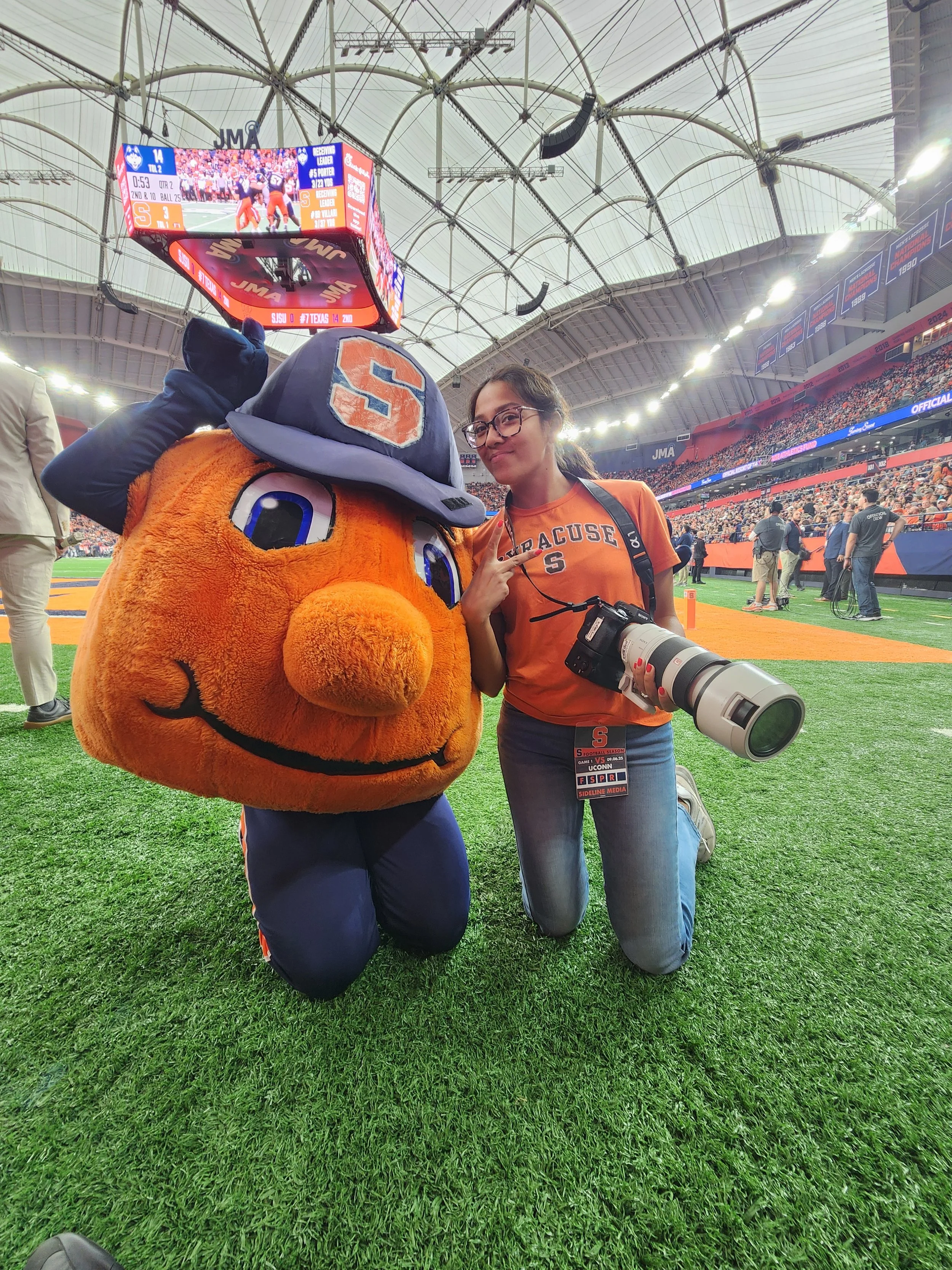 Cadence Dudley working at photog and photographed with Syracuse University mascot 'Otto.'