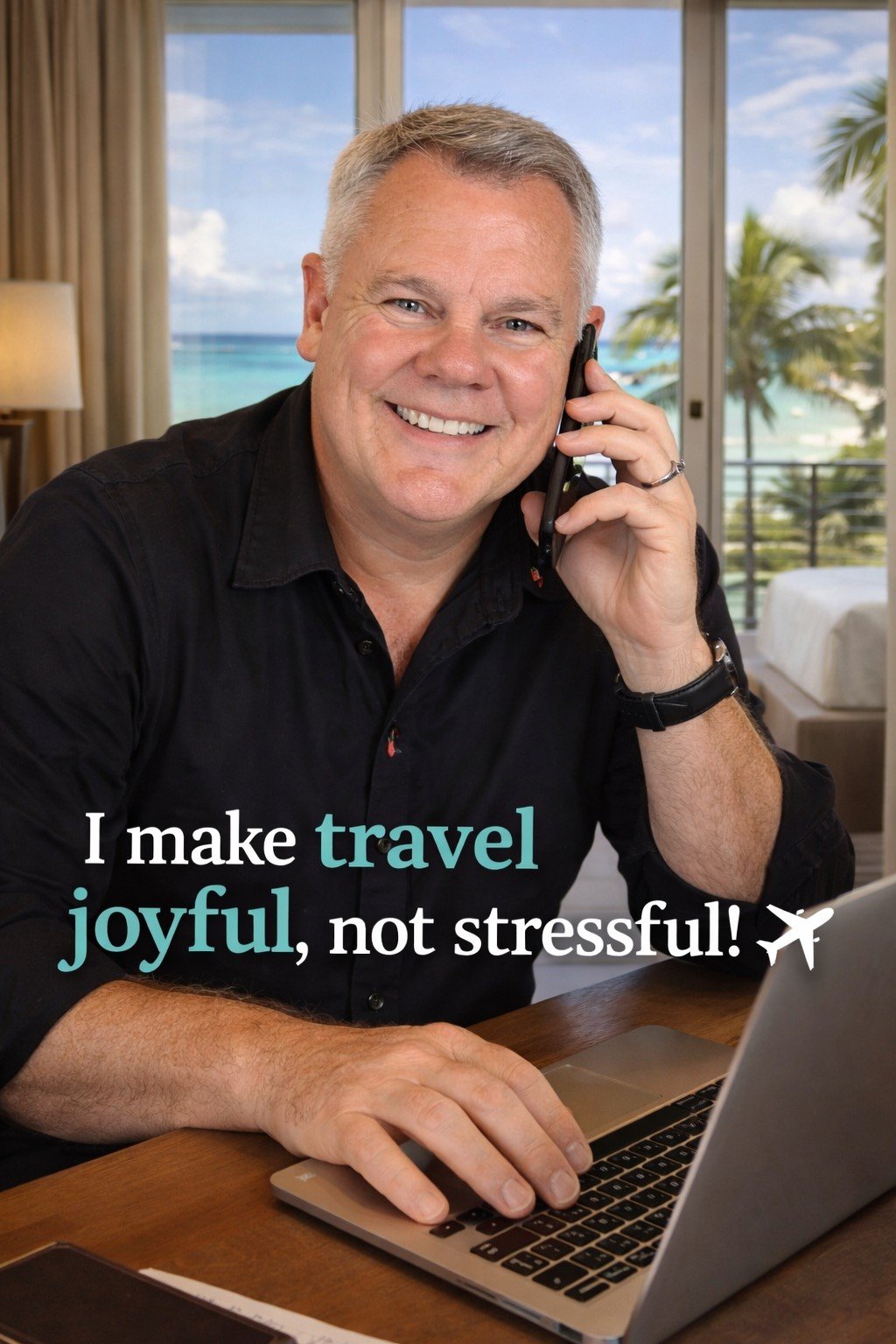 A smiling man with gray hair, wearing a black shirt, talking on a landline phone and using a laptop in a bright room with large windows overlooking a beach and palm trees.