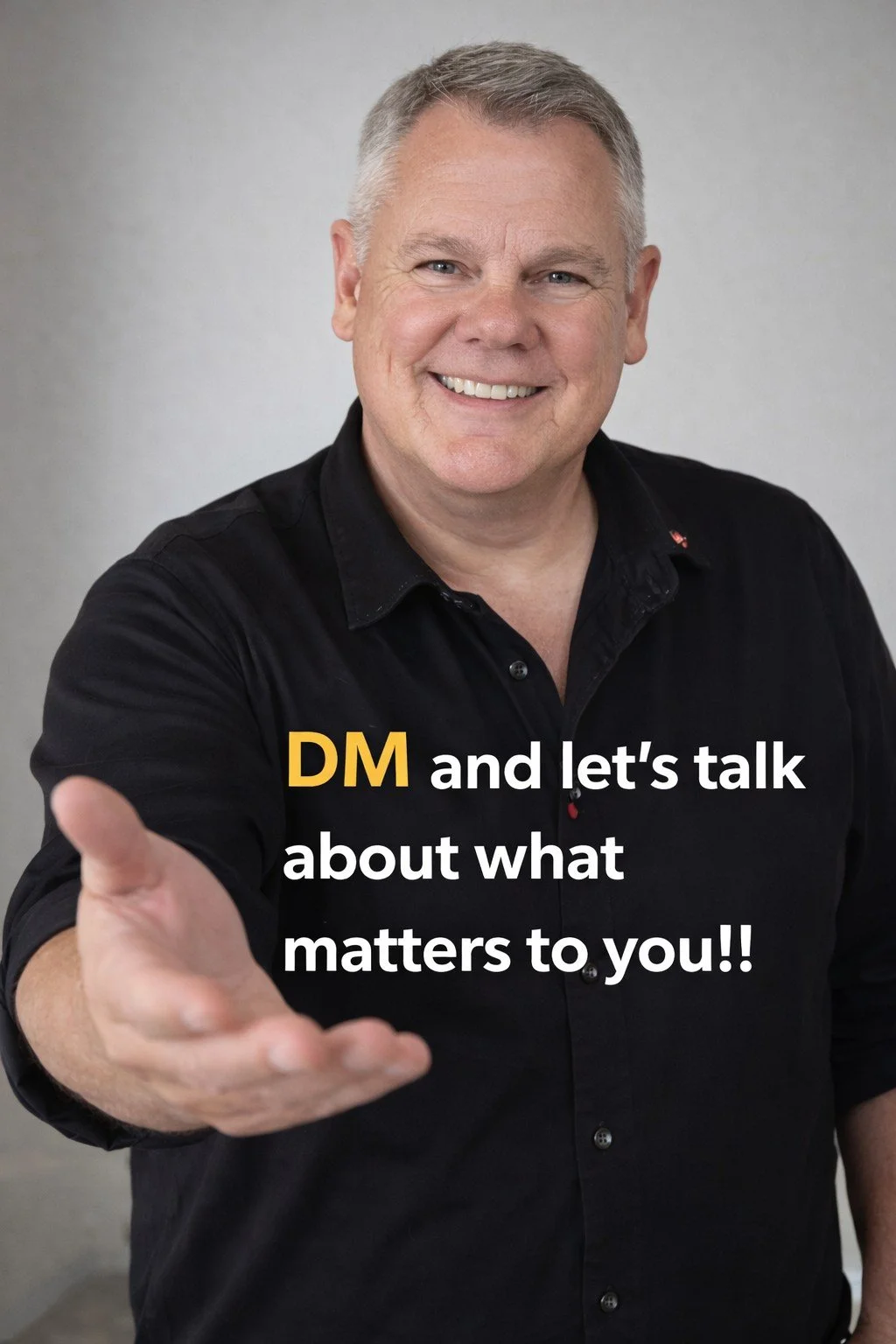 A smiling middle-aged man with gray hair, wearing a black shirt, extending his hand forward. Overlaid text reads, 'DM and let’s talk about what matters to you!!'