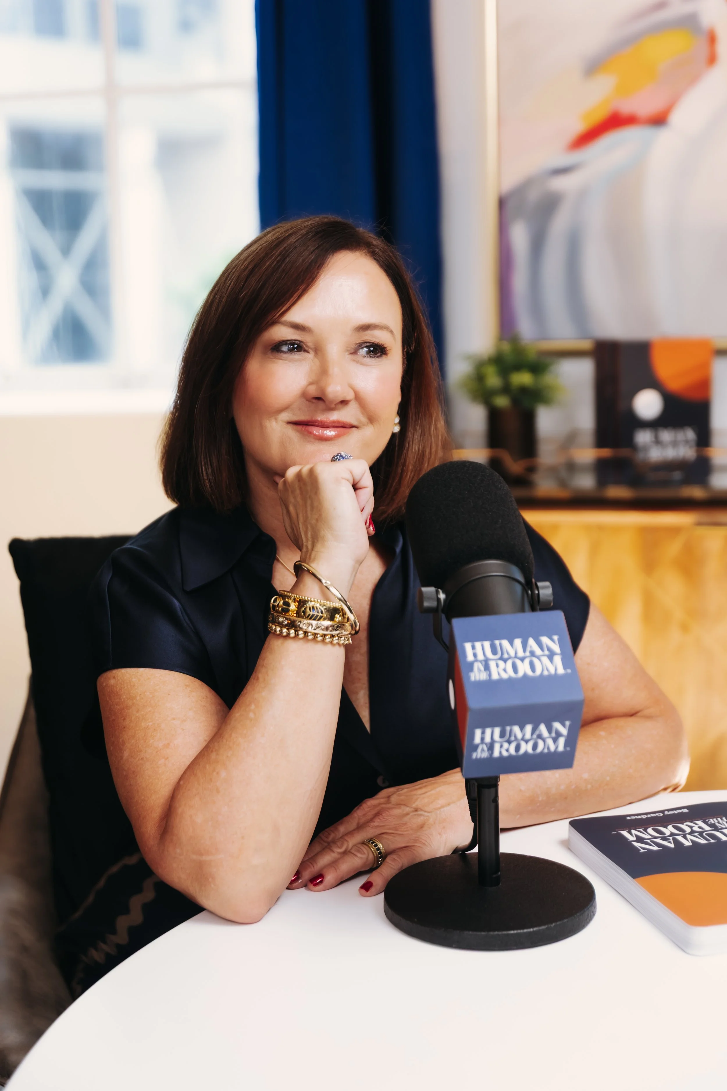 Betsy Gardner recording the Human in the Room podcast, sharing insights on leadership, workplace relationships, organizational trust, and the future of work.