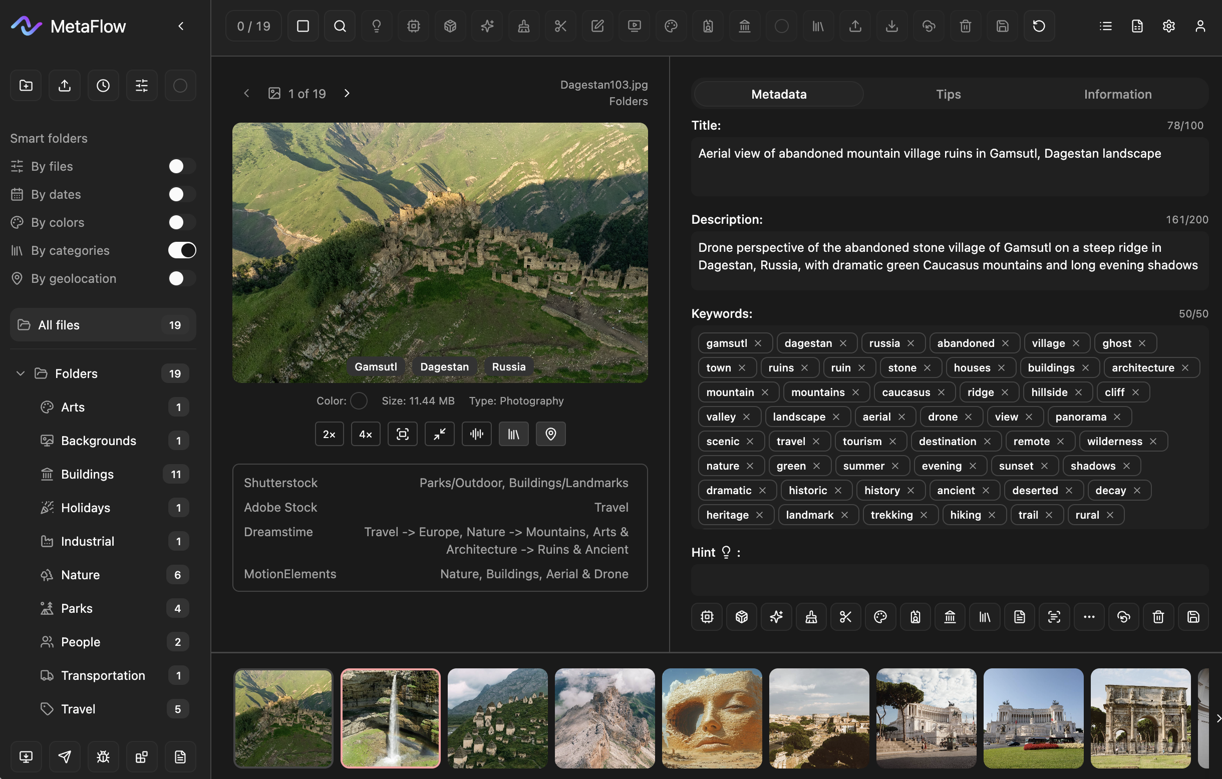 Aerial shot of abandoned stone village ruins on a mountain ridge in Dagestan, Russia, surrounded by green Caucasus slopes and valleys at sunset.