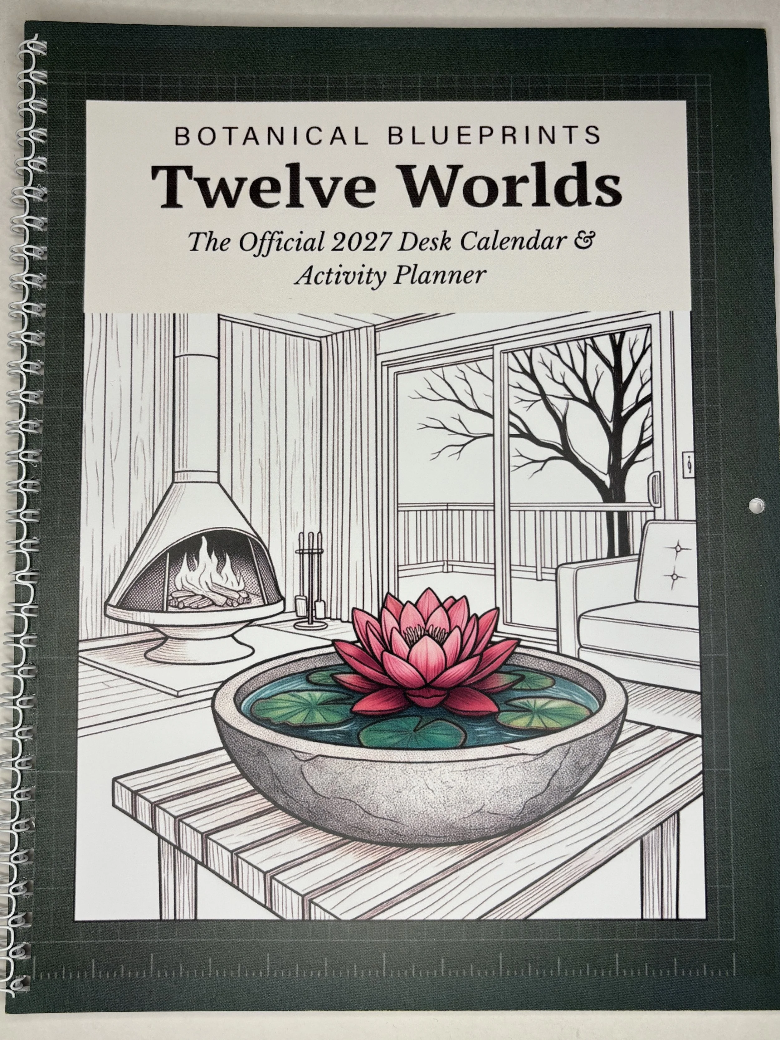 Twelve Worlds isn't just a coloring book — it's a fully dated 2027 desk calendar you're actually meant to color.  Each month pairs an original line-art illustration and themed word search with a Monday-start planning grid, Goals, and Notes section.
