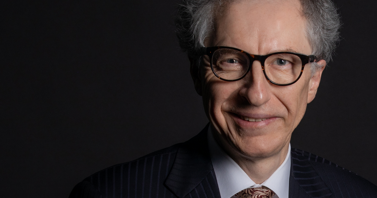 Nicholas Gruen - CEO of Lateral Economics smiling looking into the camera