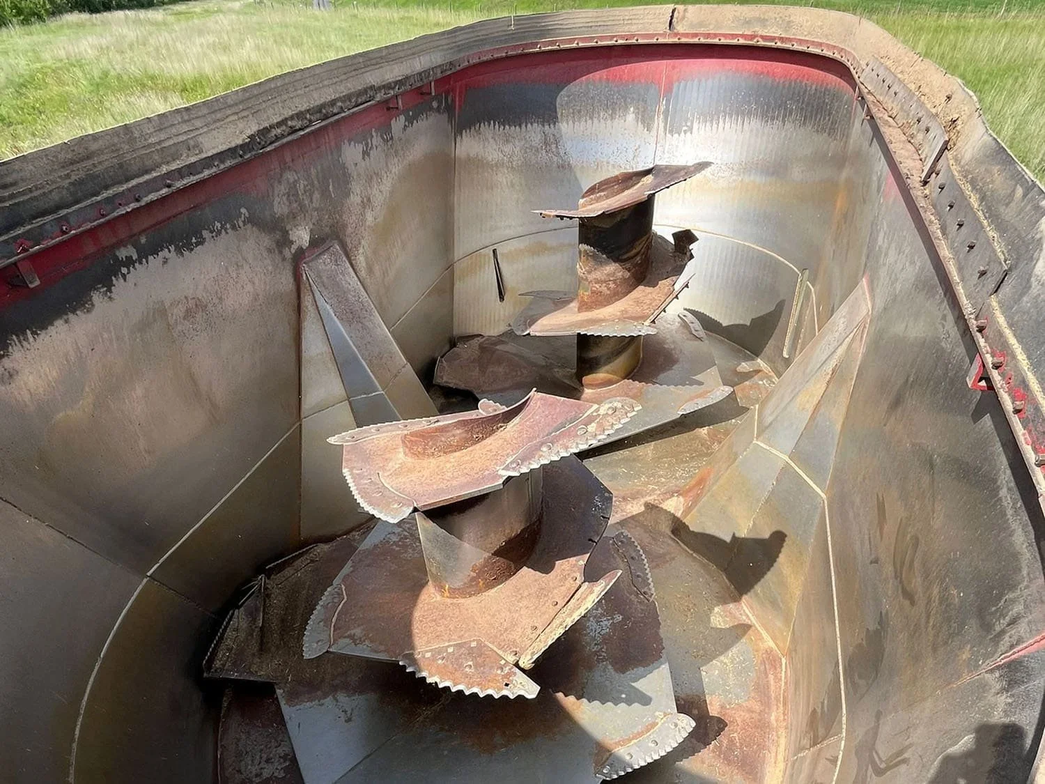 Overhead interior view looking down into the processing tub of a Jaylor TM41000 vertical feed mixer showing the twin commercial mixing augers.