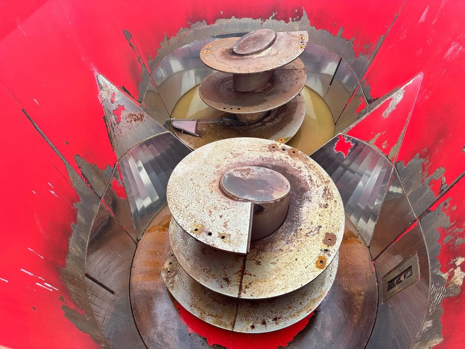 Overhead interior view showing the twin vertical mixing augers and the installed premium stainless steel tub liner wrapper inside a Rovibec Victor M90 feed mixer.