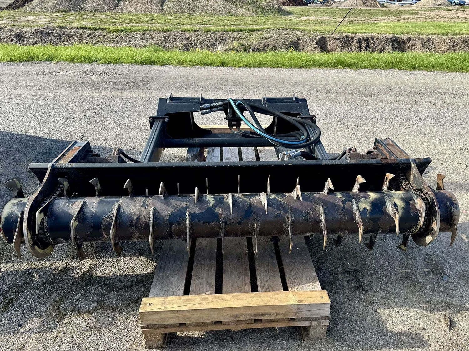 Front view of a used HLA SBFD84AO600 84 inch silage bunk facer attachment sitting on a shipping pallet for sale at Siloking Canada.