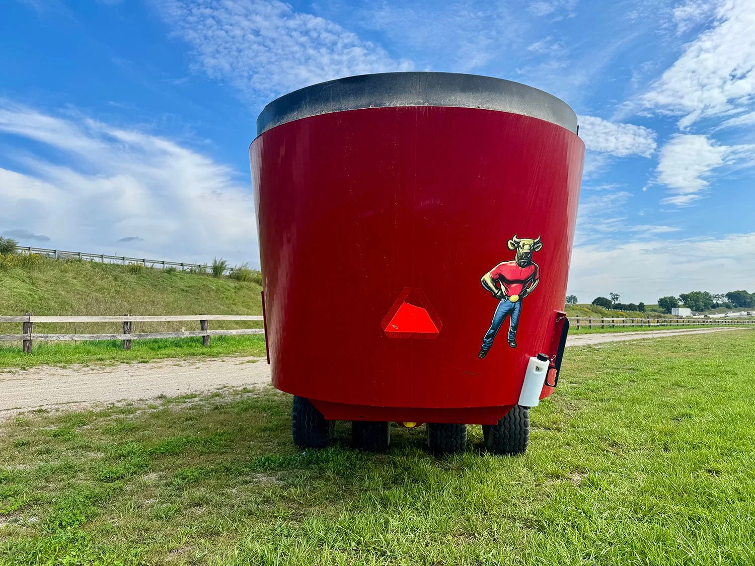 Straight rear view of a used red 2021 Jaylor 5850 twin auger vertical TMR feed mixer showing overall tub profile and tandem axle setup.