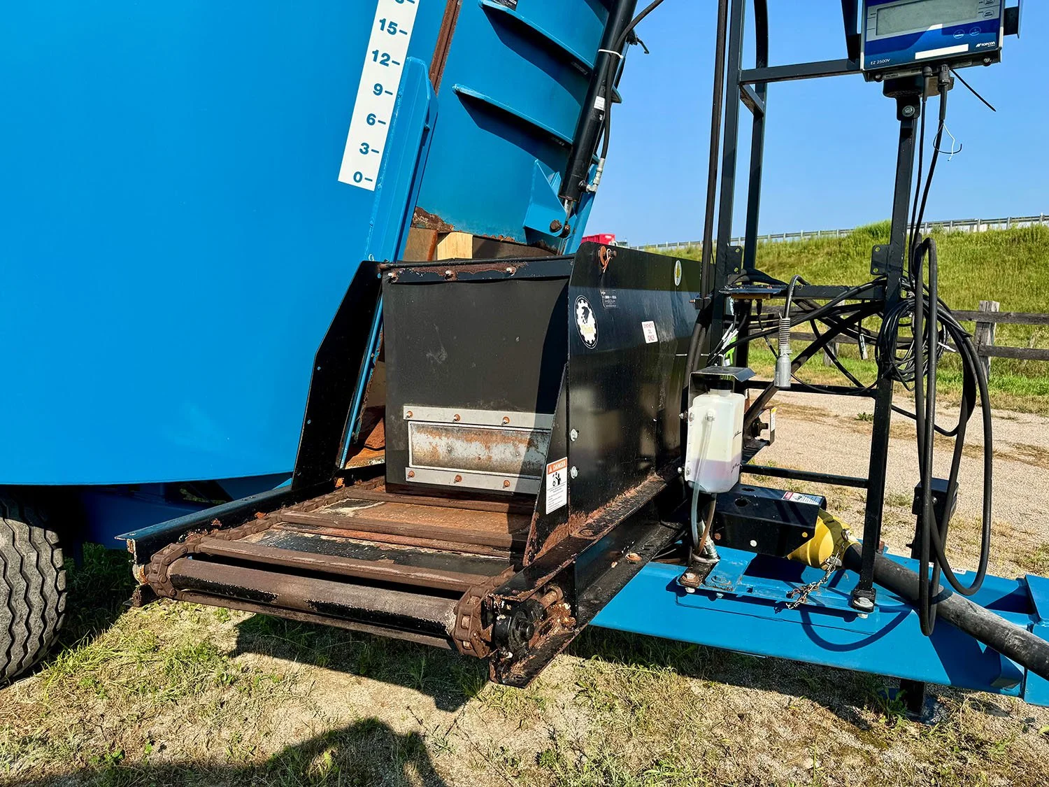 Close-up of the front chain cross conveyor discharge system on a Lucknow 1480 vertical mixer.