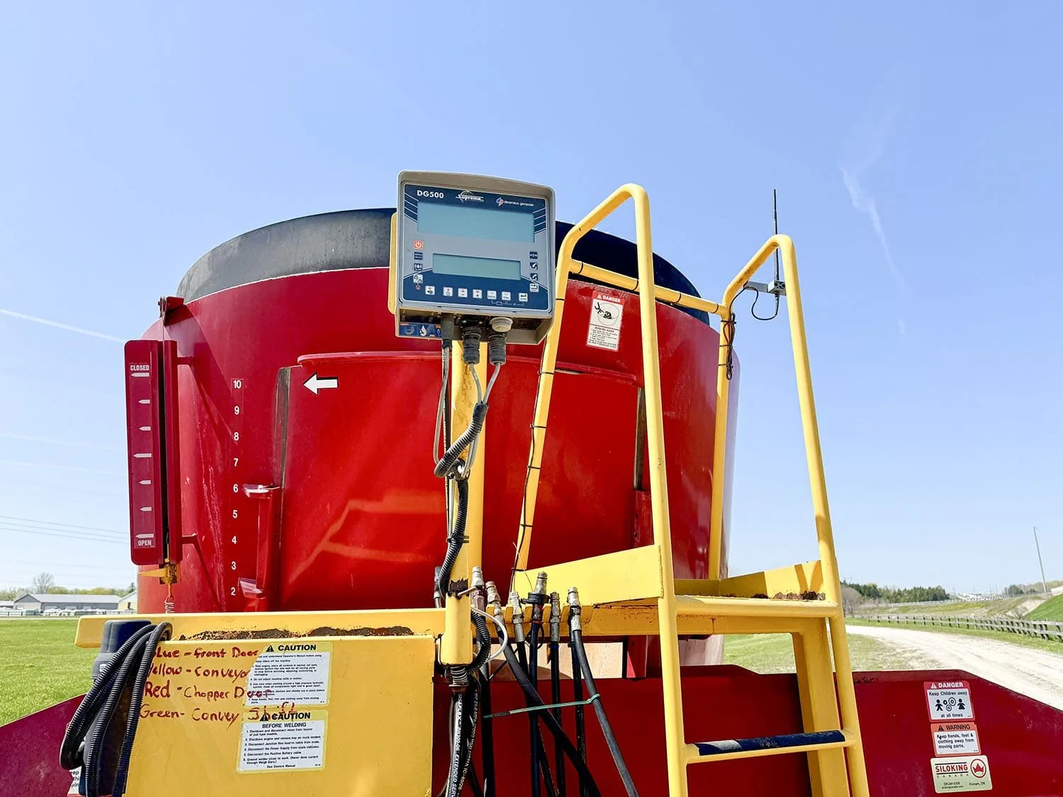 Close-up view of the DG500 Dinamica Generale electronic weigh scale head indicator mounted beside the front platform ladder on a Supreme mixer.