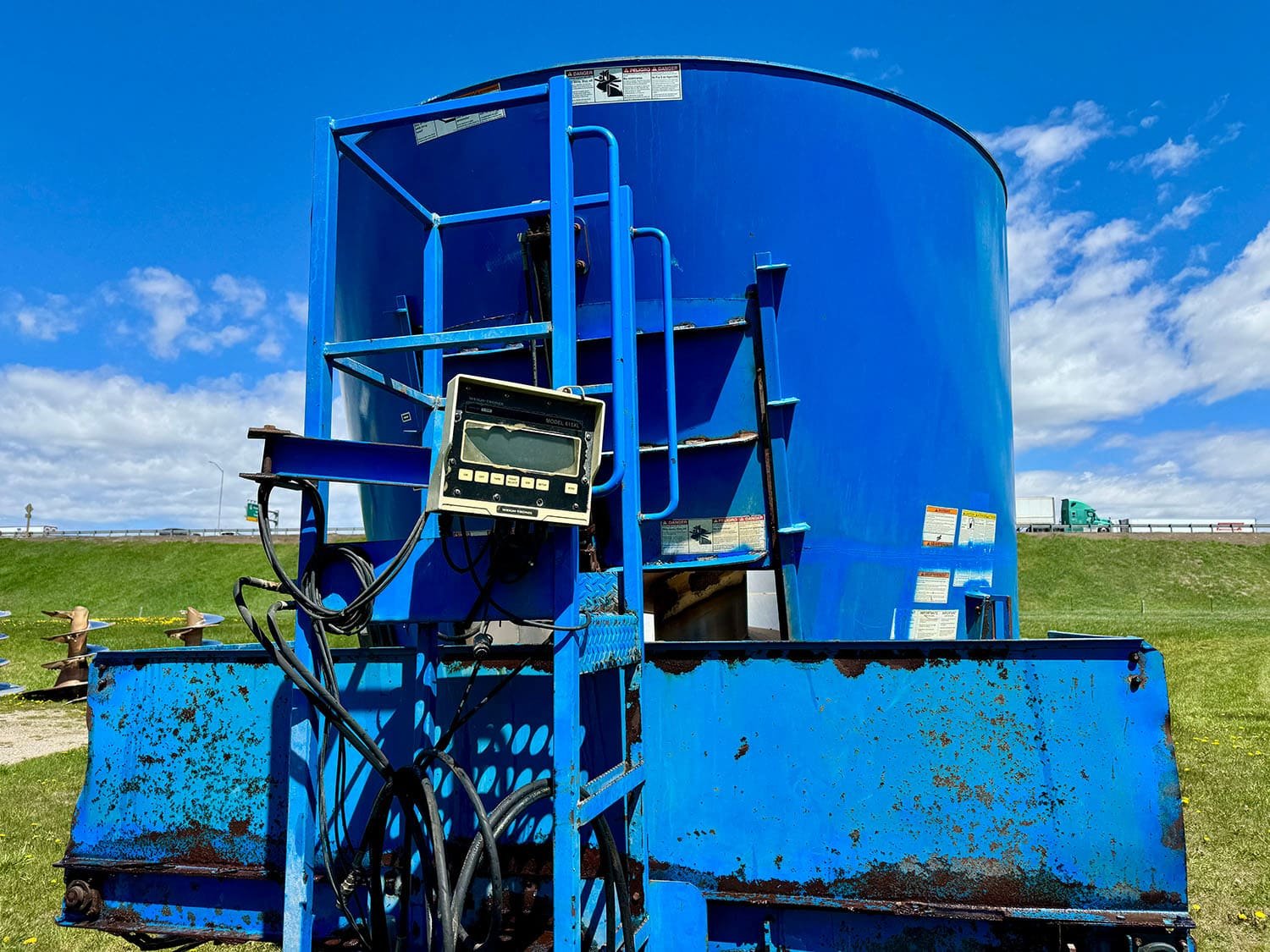 Close-up front view of the operator ladder platform and a Weigh-Tronix 615XL electronic weigh scale box indicator head on a Patz mixer.