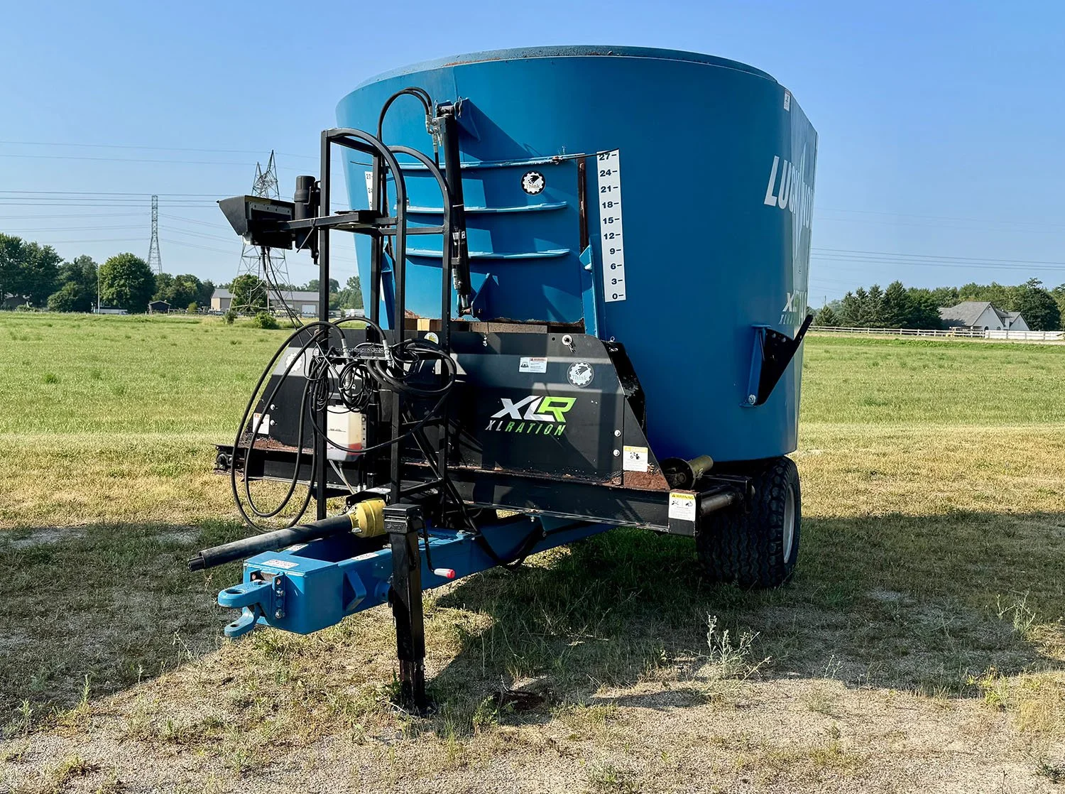 Front view of a used Lucknow XLRation 1480 trailed TMR mixer showing the hitch, PTO drive, and ladder setup.