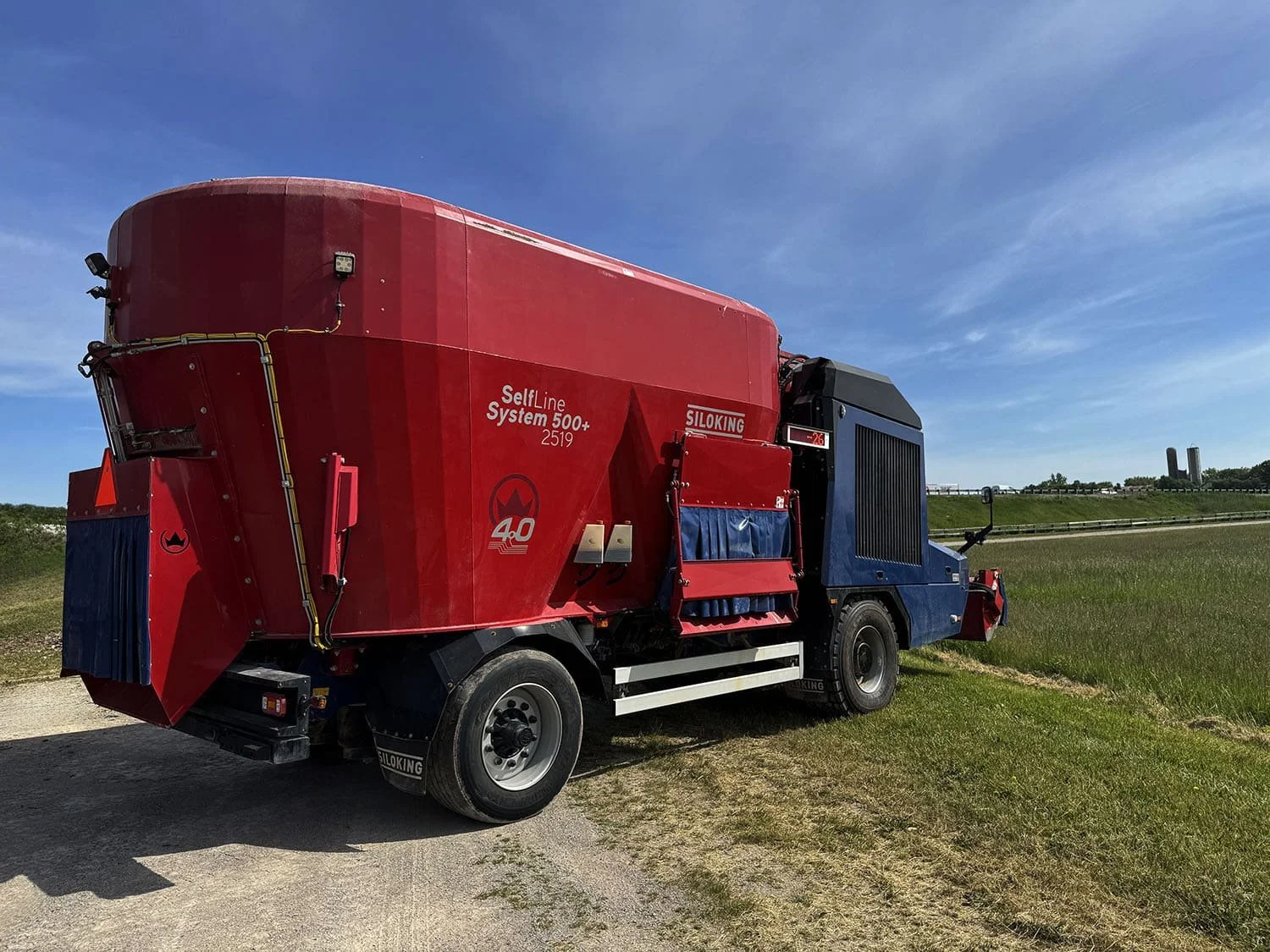 Rear three-quarter perspective view of a used 2023 Siloking SelfLine 4.0 self-propelled feed mixer showing the dual axle tire layout and side discharge assembly.
