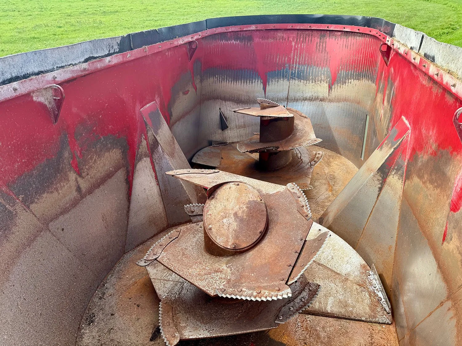 Overhead interior view showing twin vertical mixing augers and processing knives inside a 2021 Jaylor 5850 feed mixer tub.