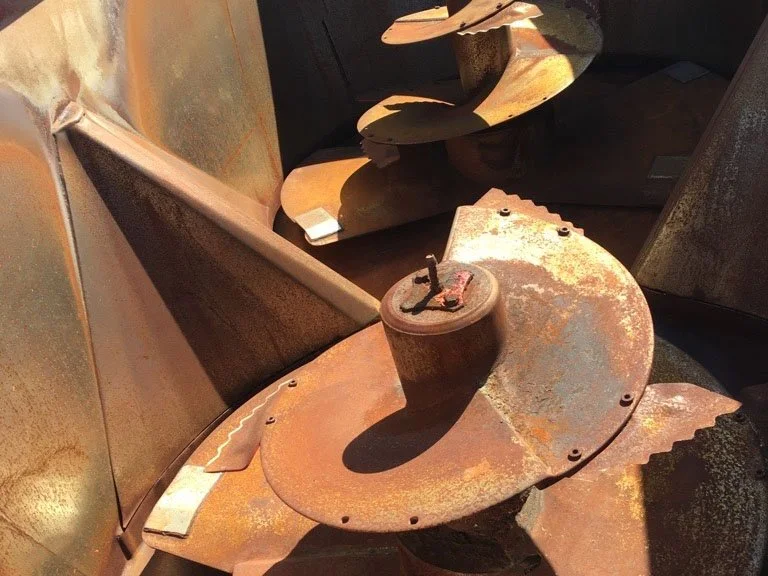 Interior overhead view of the processing tub on a Trioliet Solomix 2 2000 vertical feed mixer showing the dual vertical mixing augers.