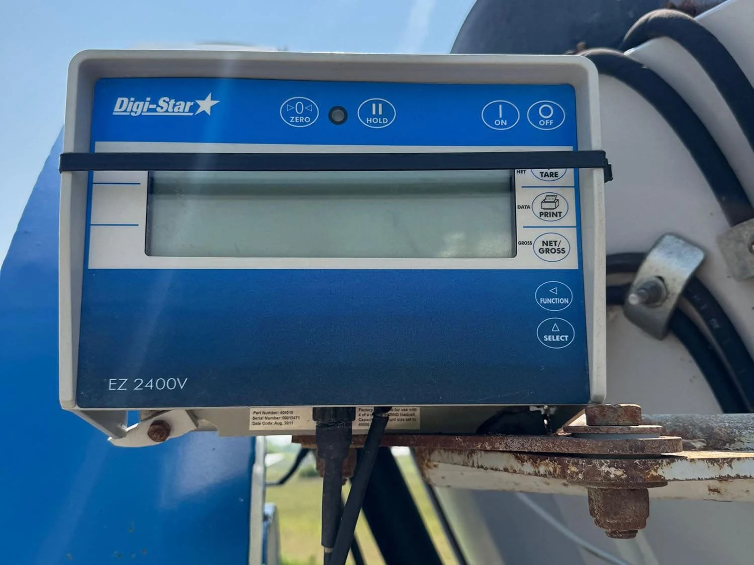 Close-up view of the DigiStar EZ-2400V electronic weigh scale indicator head mounted on a bracket on the side of a Penta TMR mixer wagon.