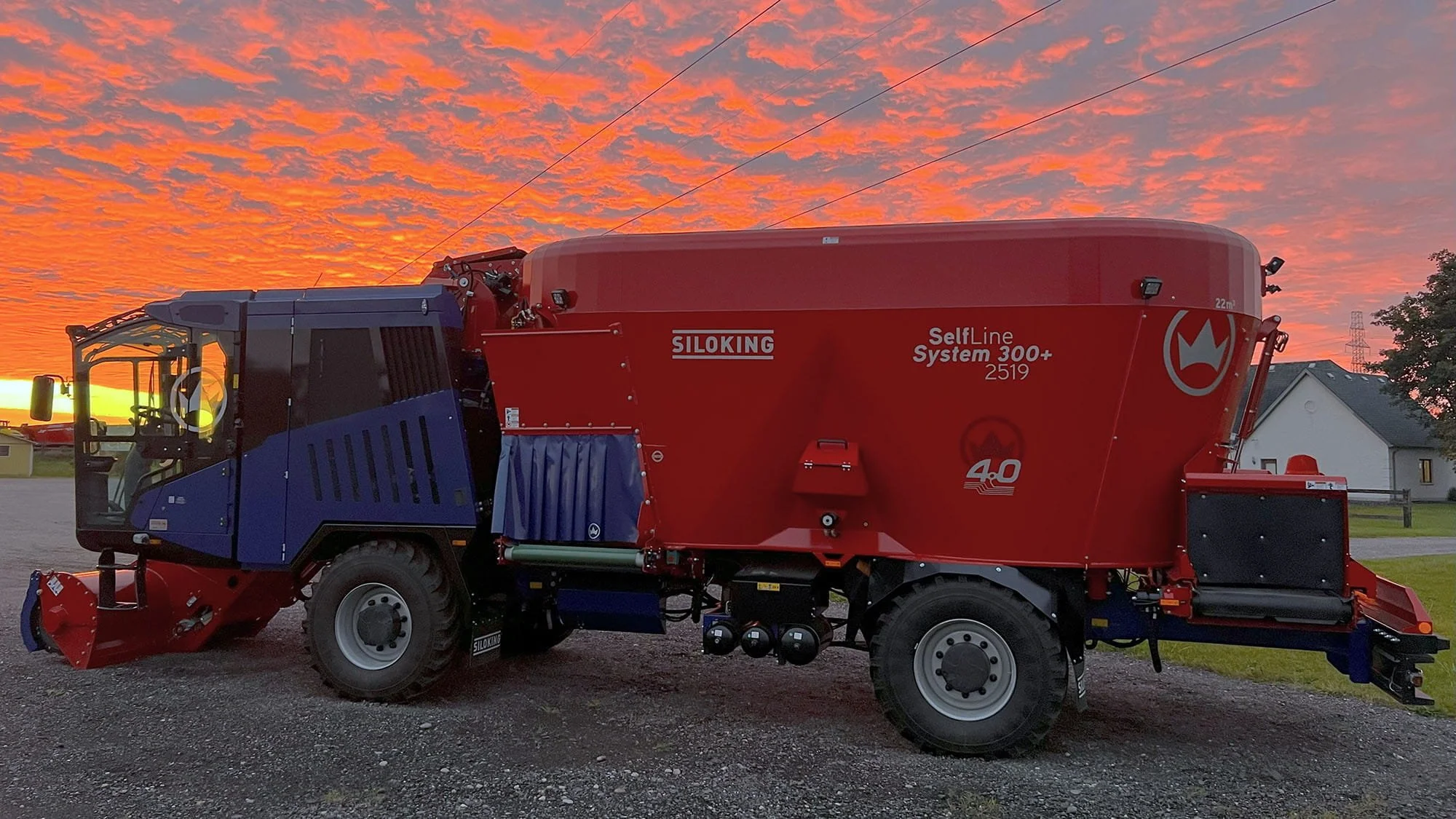 Full side profile view of a Siloking SelfLine System 300 plus 2519 self-propelled TMR feed mixer parked outdoors during an Ontario sunset.