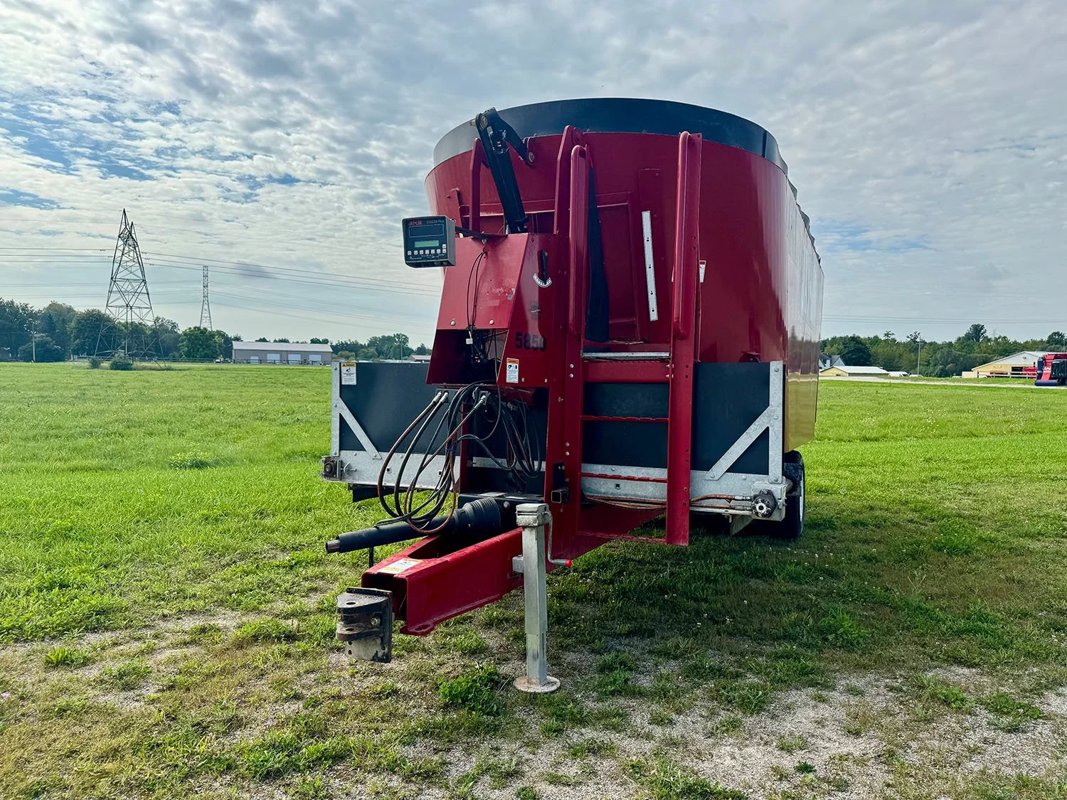 Direct front view of a used 2021 Jaylor 5850 vertical TMR mixer wagon showing drawbar hitch, PTO drive shaft, front ladder, and scale head.