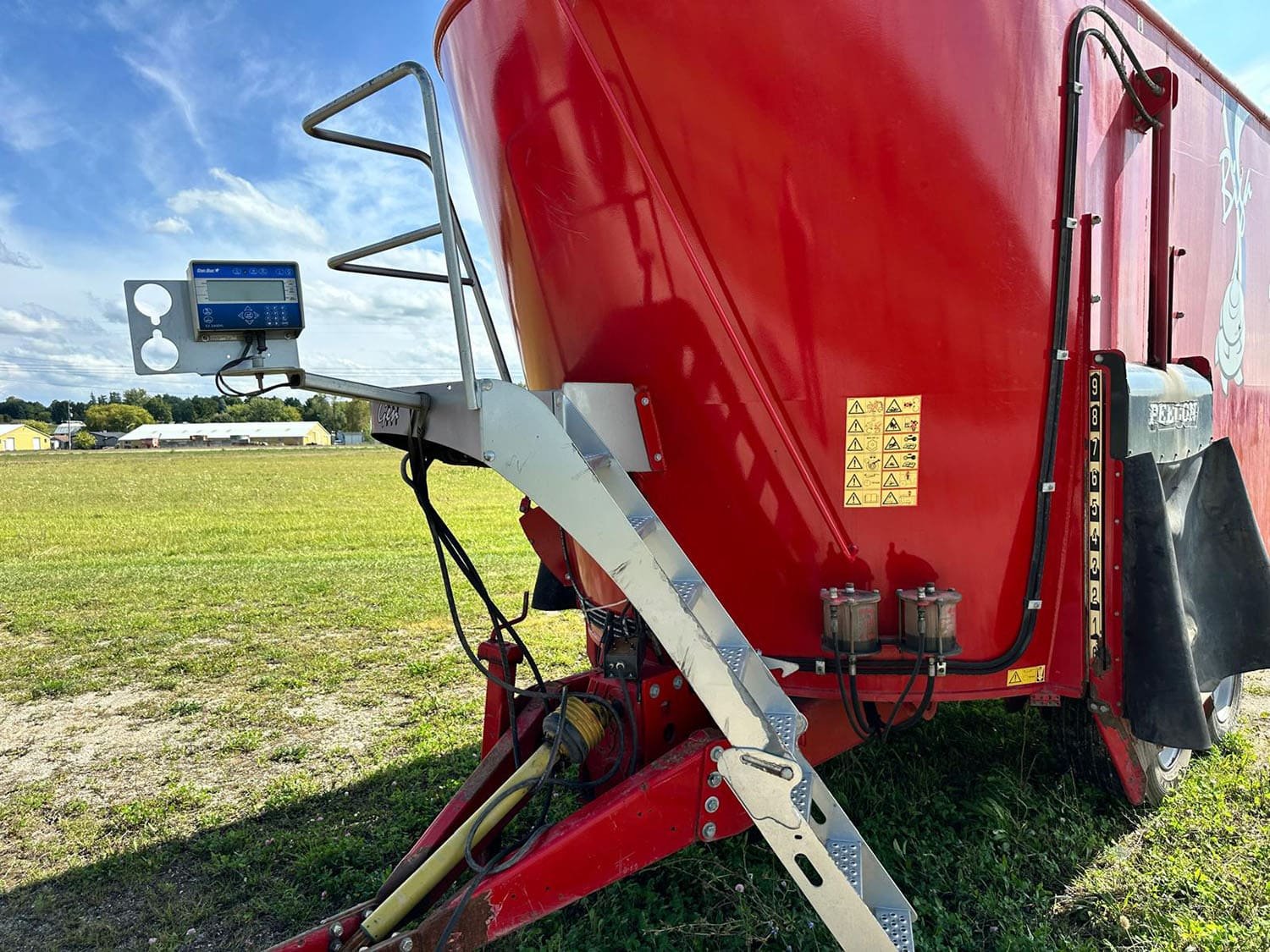 Close-up view of the DigiStar EZ 3400VL electronic weigh scale indicator head mounted on the front platform of a Peecon vertical TMR mixer.