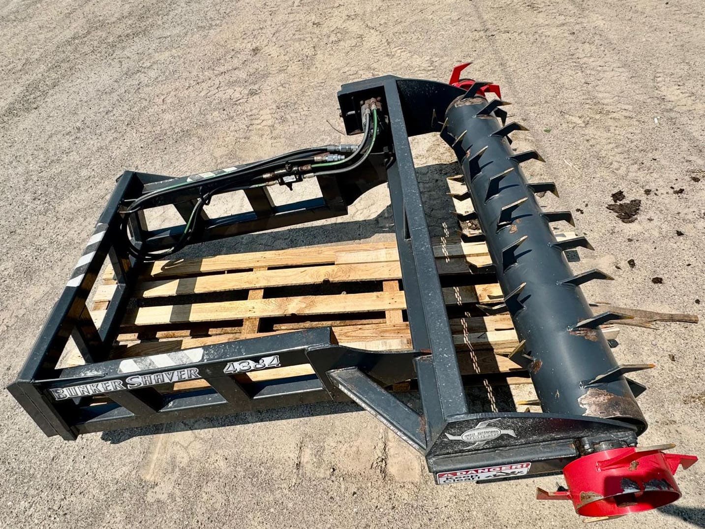 Used 4384 Bunker Shaver 84 inch silage scraper skid steer attachment sitting on a shipping pallet for sale at Siloking Canada.