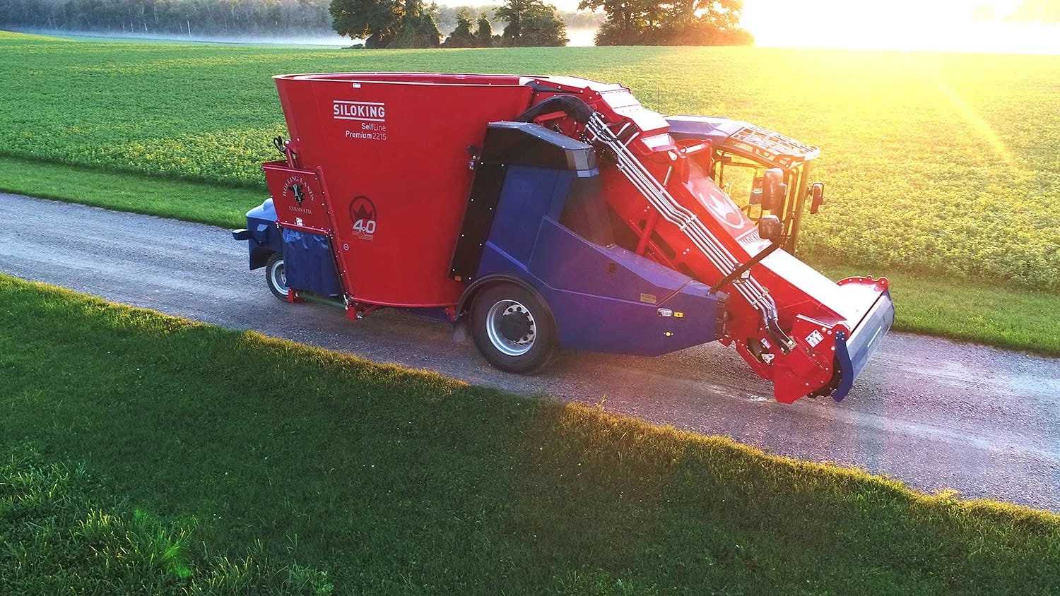 Ground-level three-quarter profile of a parked Siloking SelfLine Premium 2215 single-auger self-propelled TMR mixer highlighting the operator cab and silage loading conveyor channel.