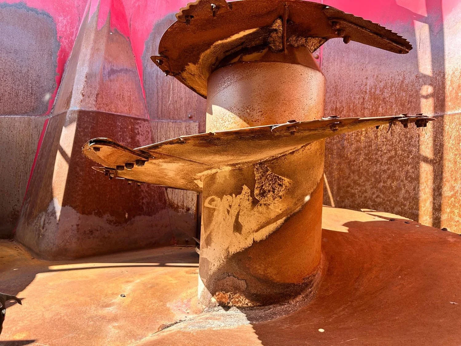 Overhead interior view showing the massive vertical mixing auger and installed inner tub liner wrapper inside a used 30 cubic meter Peecon feed mixer.