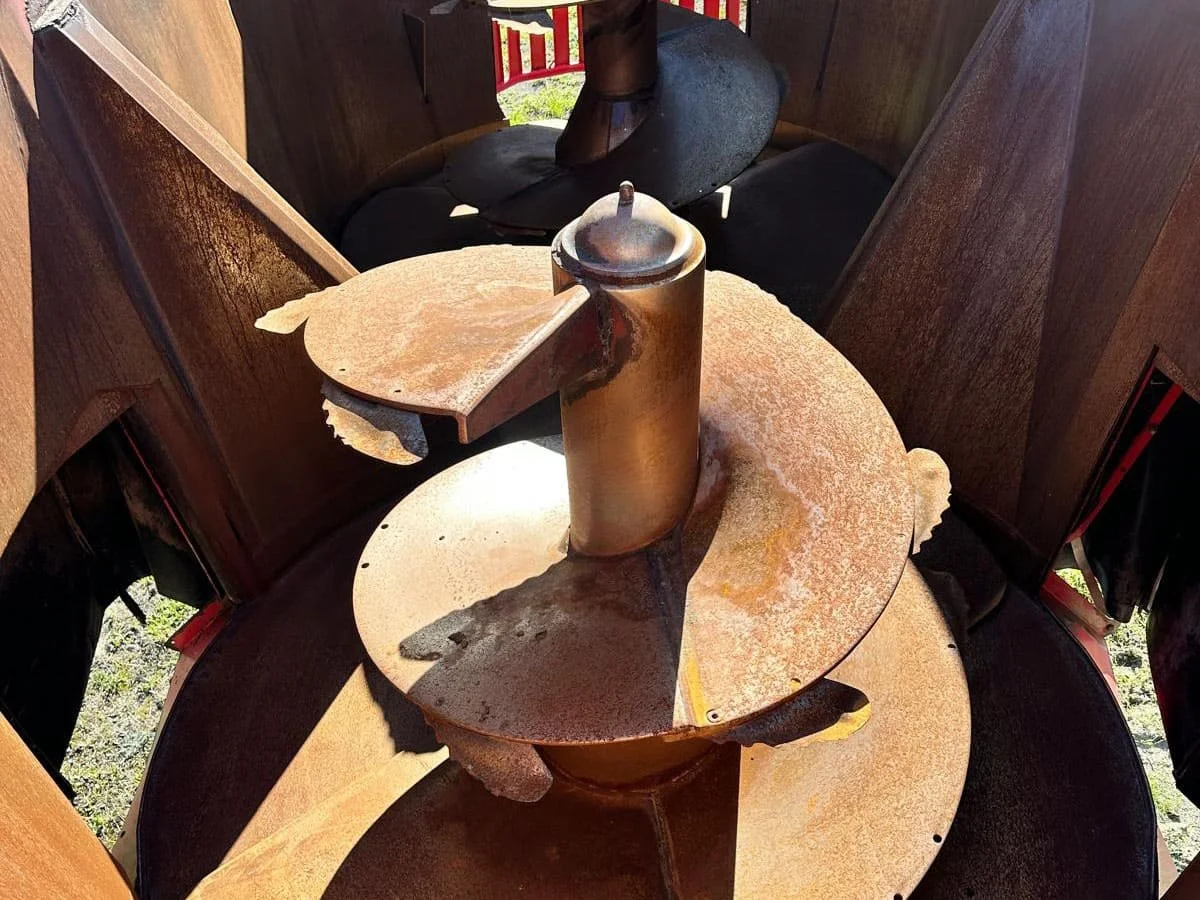 Overhead interior view showing the twin vertical mixing augers and long life flighting knives inside a used 28 cubic meter Trioliet feed mixer tub.
