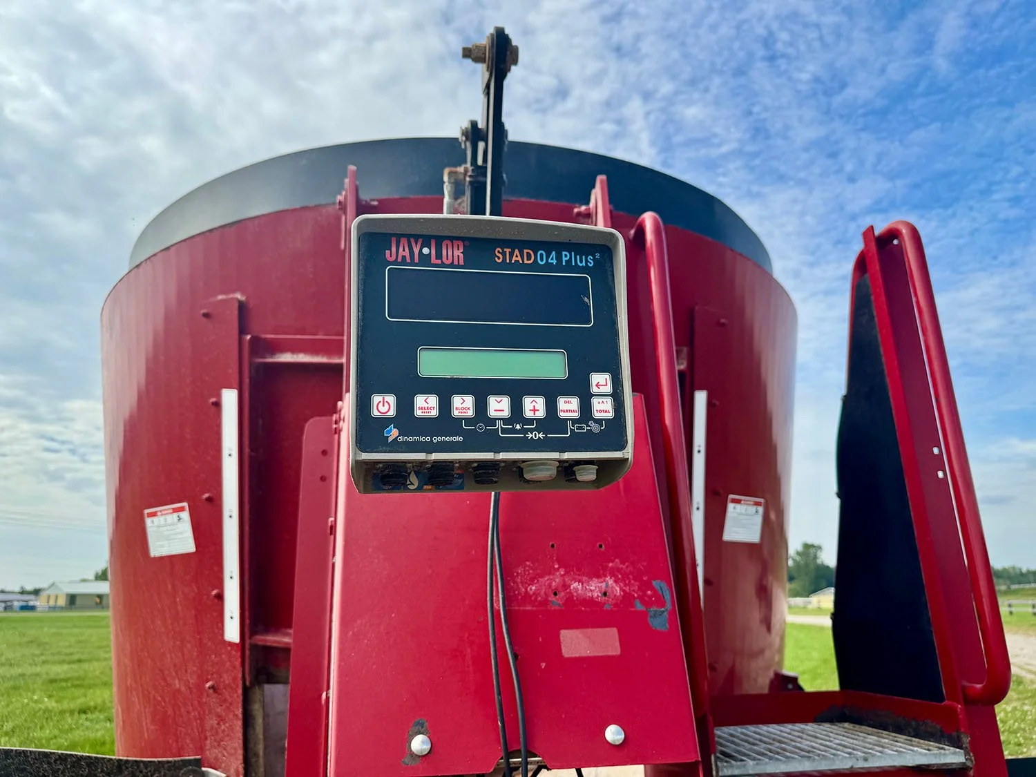 Close-up view of the Dinamica Generale STAD04 Plus2 electronic weigh scale indicator head mounted on a Jaylor TMR mixer.