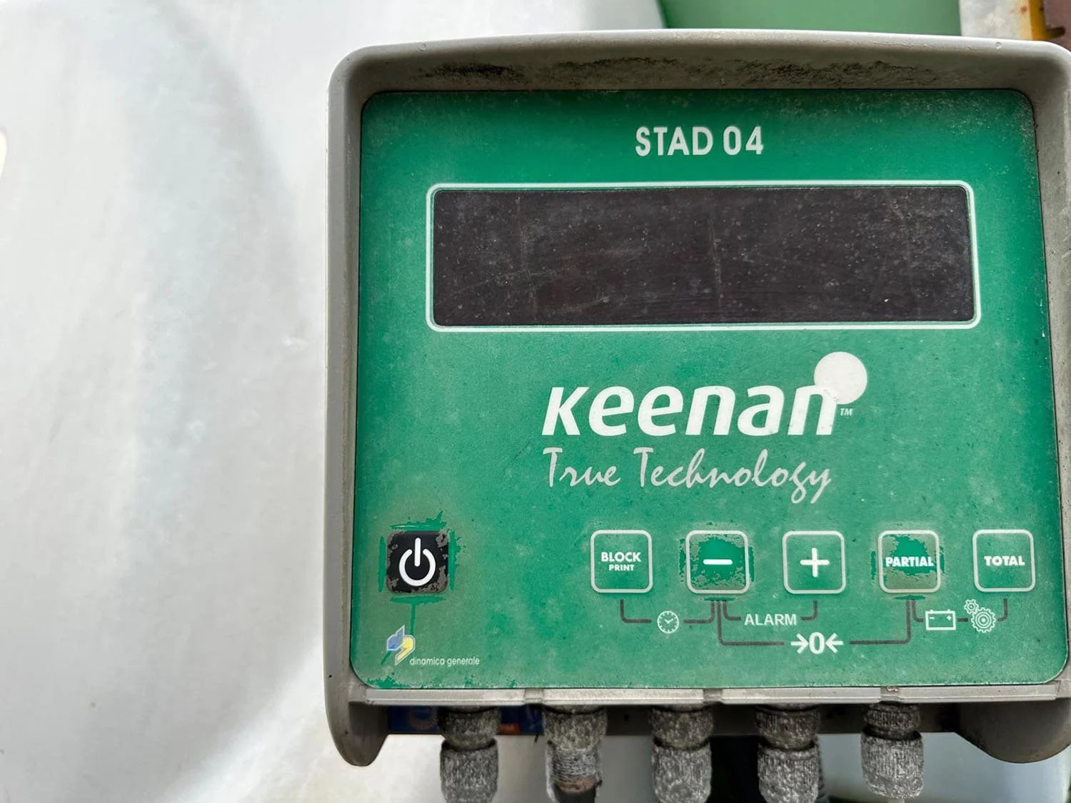 Close-up view of the green Keenan True Technology Stad 04 electronic weigh scale box indicator head on a used horizontal TMR mixer wagon.