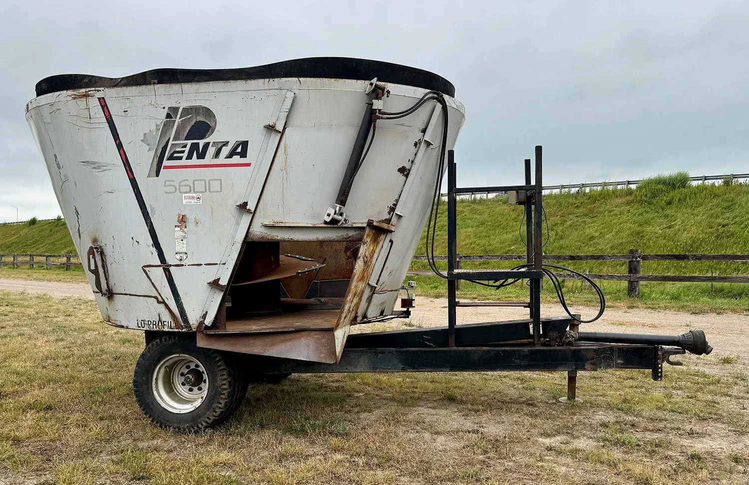 Right side profile of a used Penta 5600 TMR mixer showing the right hand discharge door opening.
