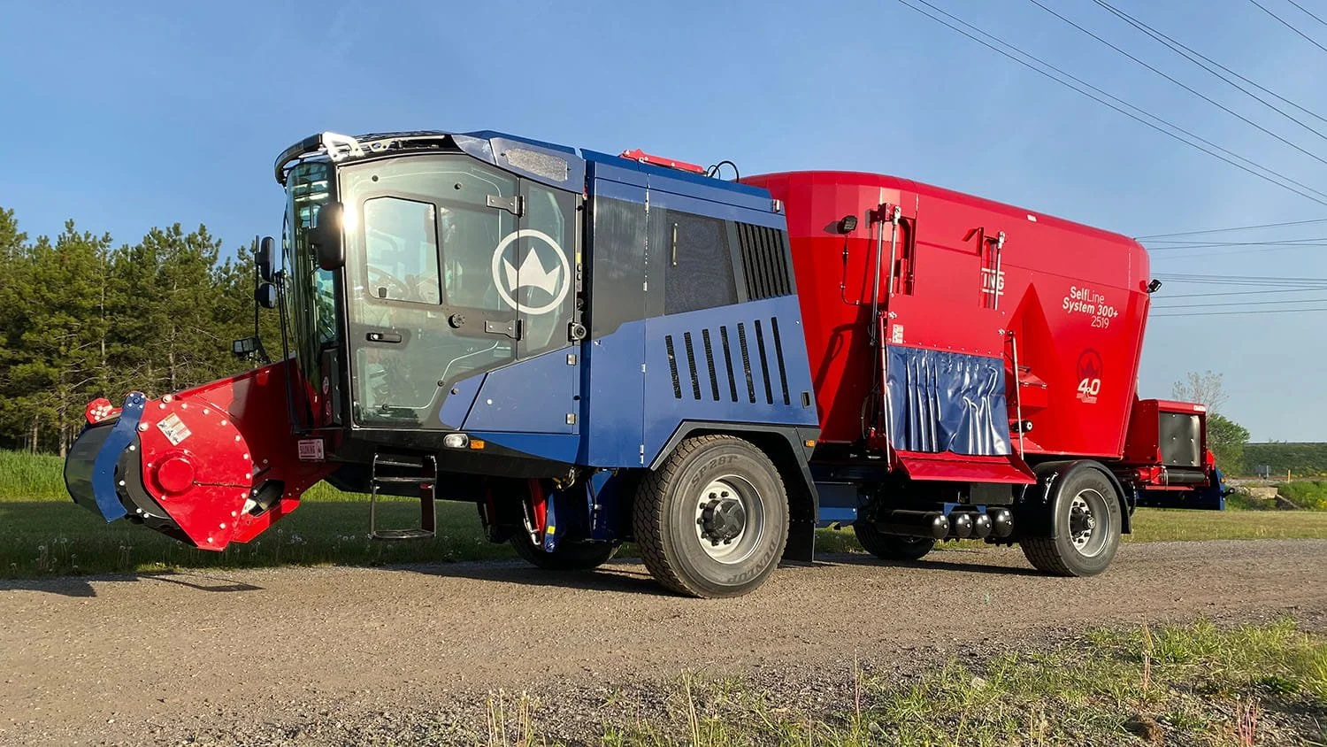 Three-quarter front angle shot of a Siloking SelfLine System 300 plus 2519 vertical self-propelled feed mixer standing on a rural gravel lane in summer.