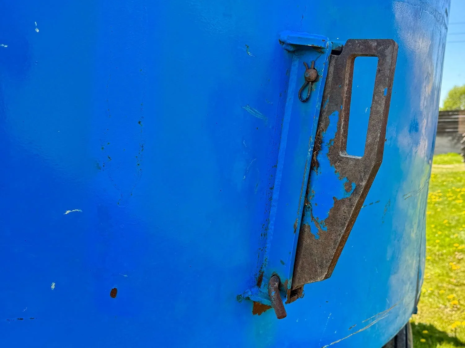 Detailed close-up view of the heavy-duty metal protection magnet mounted on the outer blue tub wall of a Patz vertical mixer.