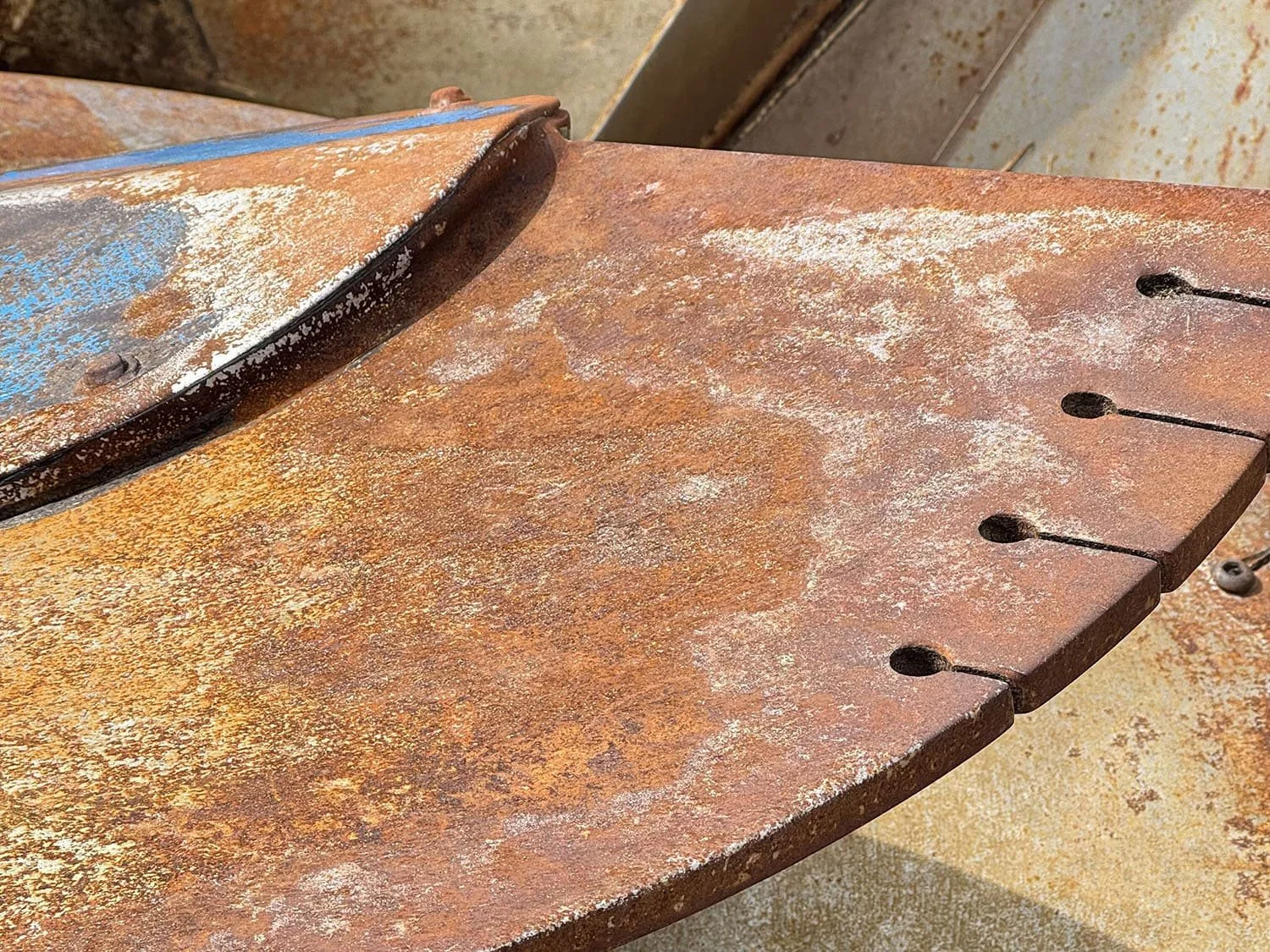 Detailed close-up view of the vertical auger and serrated knives showing wear patterns inside a used Patz TMR mixer.