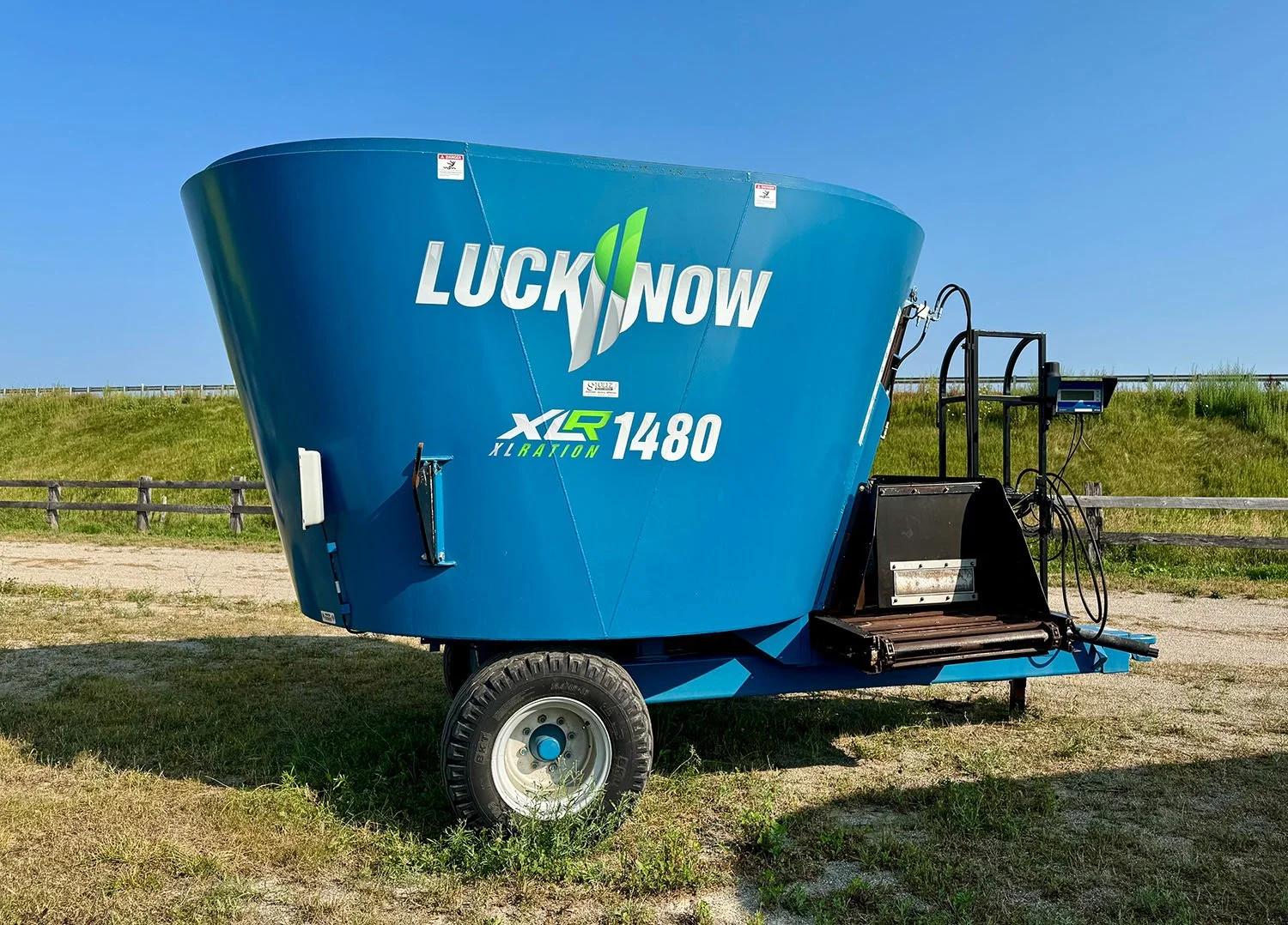 Left side profile view of a blue used Lucknow XLRation 1480 TMR vertical mixer on single axle.