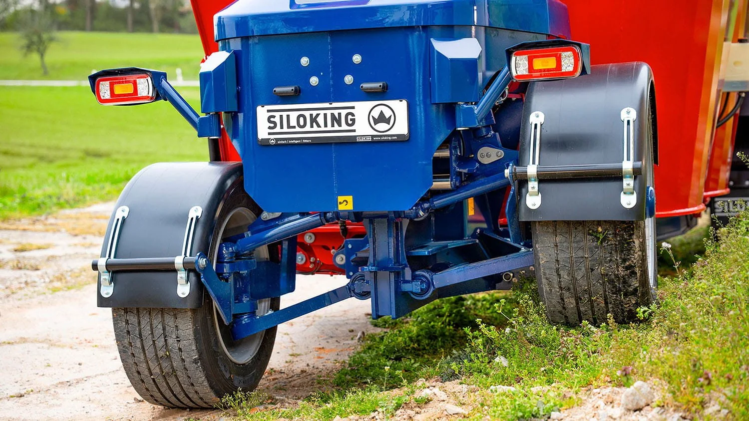 Close-up view of the rugged independent front wheel suspension and steering assembly on a heavy-duty Siloking self-propelled mixer chassis.