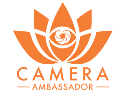 Orange lotus flower with a camera aperture symbol at the center, and the words "Camera Ambassador" underneath.