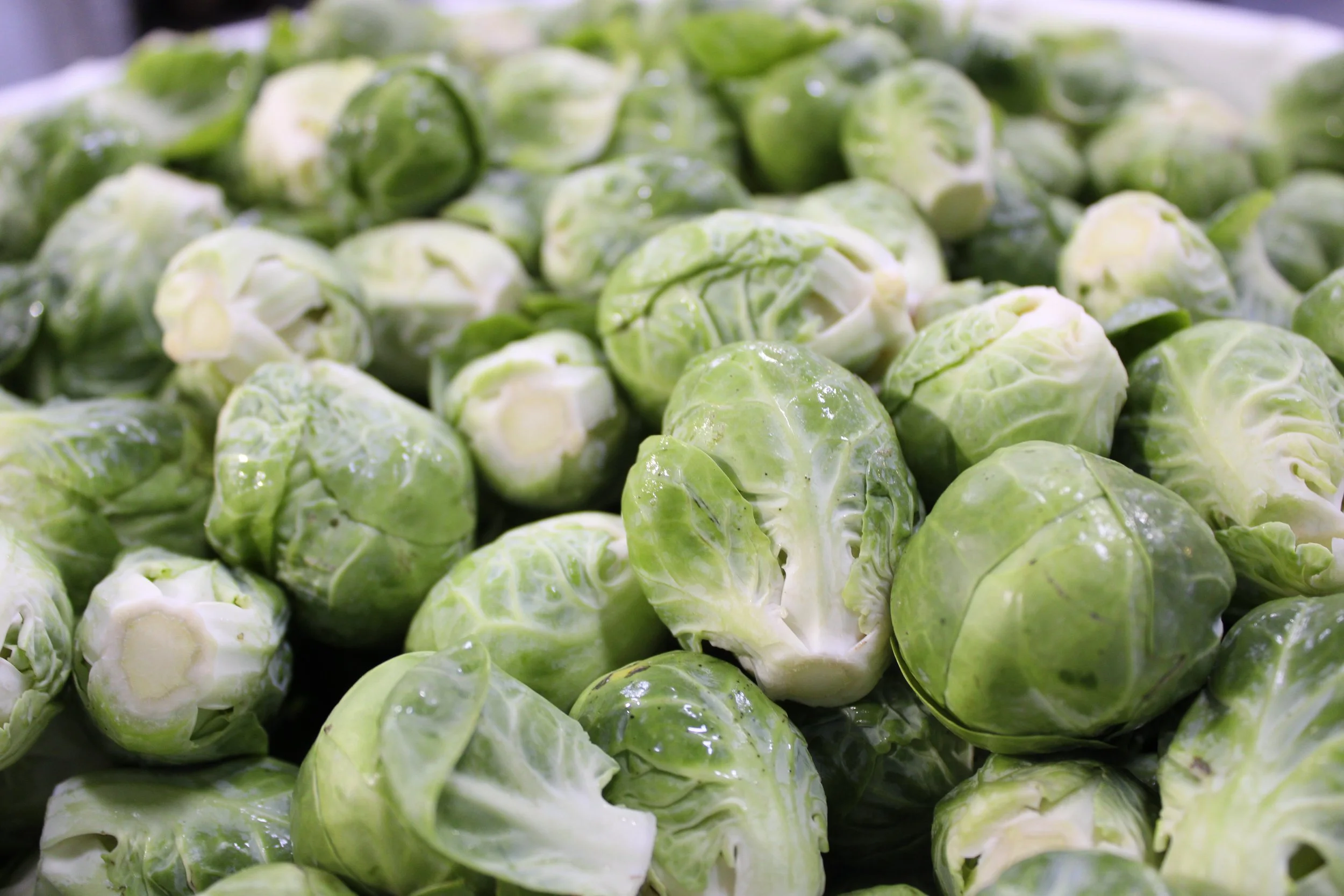 Close-up of fresh Brussels sprouts, green and tightly packed.