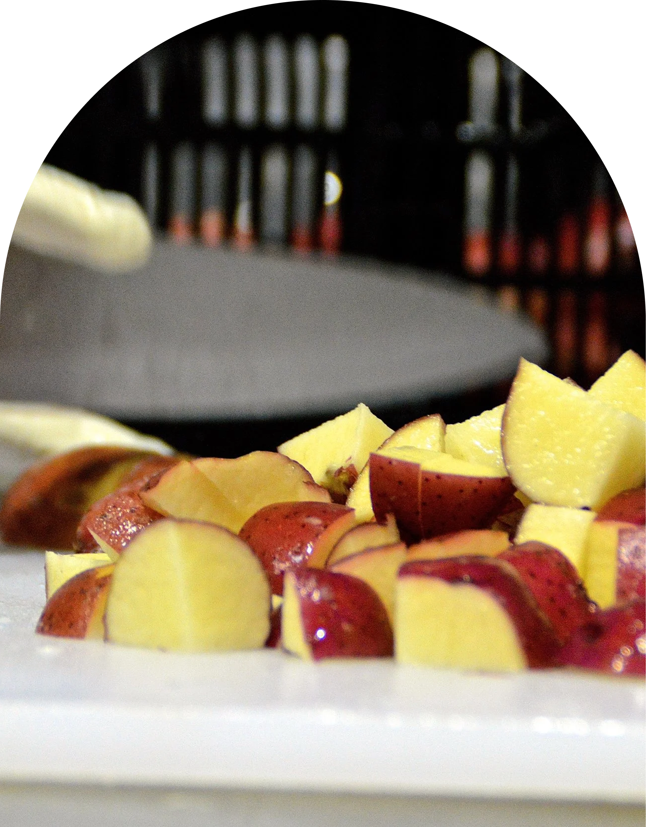 Close-up image of sliced red apples and yellow pineapple chunks on a white plate.